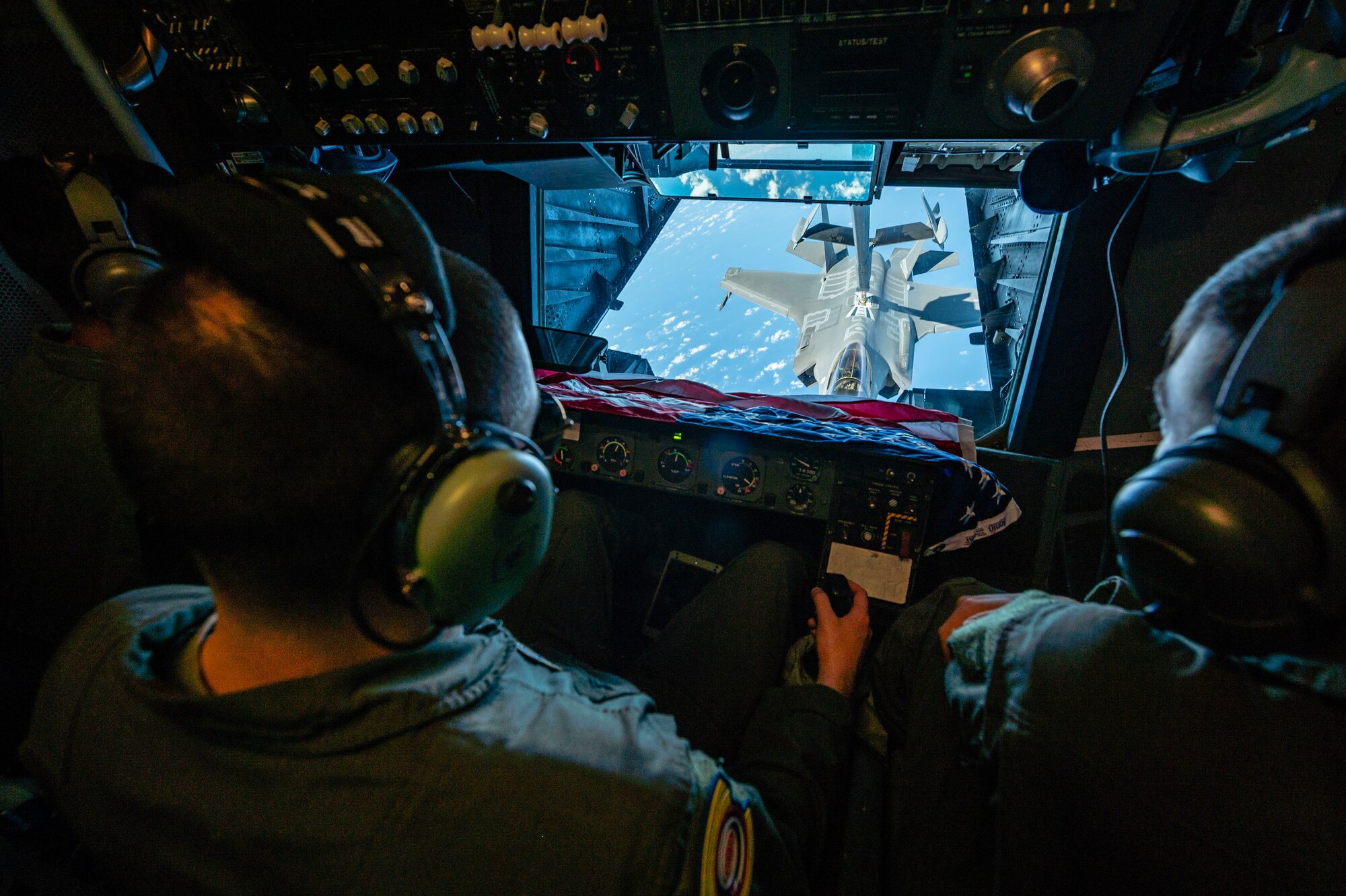 A man refuels a jet on air