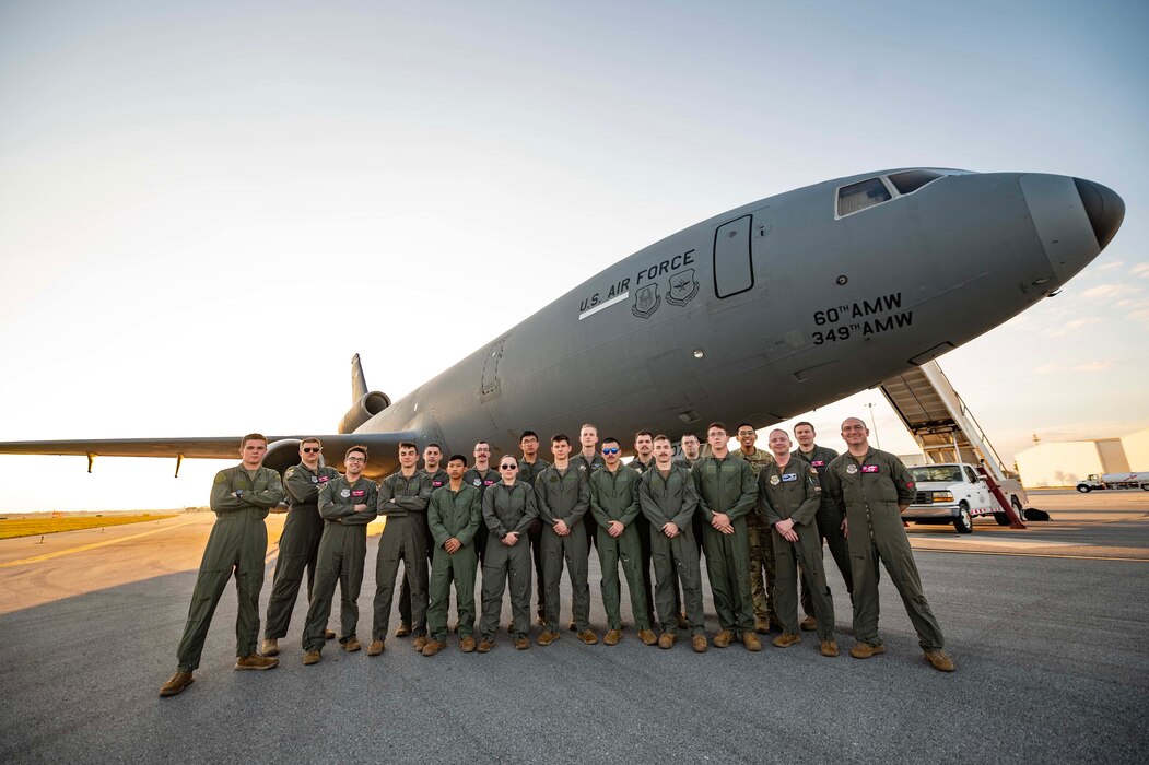 Airmen from the 9th Air Refueling Squadron and Embry-Riddle Aeronautical University Air Force Reserve Officer Training Corps cadets gather for a photo in front of a KC-10 Extender after an incentive flight at Daytona Beach International Airport, Florida, March 1, 2023
