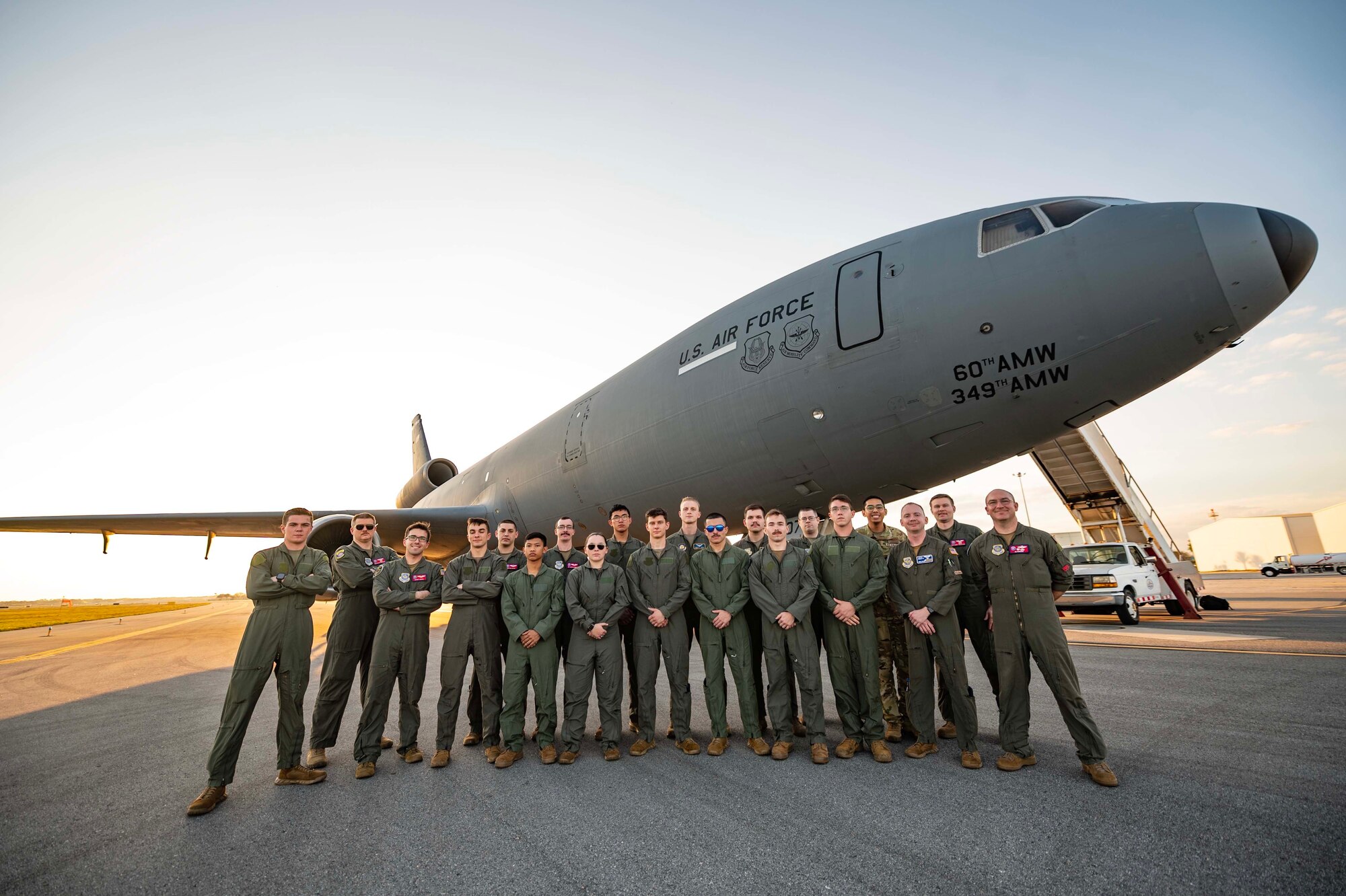 Airmen from the 9th Air Refueling Squadron and Embry-Riddle Aeronautical University Air Force Reserve Officer Training Corps cadets gather for a photo in front of a KC-10 Extender after an incentive flight at Daytona Beach International Airport, Florida, March 1, 2023