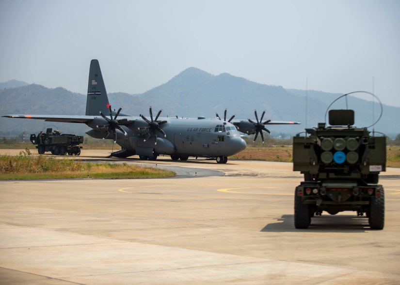 A 302nd Airlift Wing C-130H Hercules delivers a missile pod for a U.S. Marine Corps High Mobility Artillery Rocket System at Khok Kathiam Royal Thai Air Force Base, Kingdom of Thailand, during Exercise Cobra Gold 23, March 6, 2023.