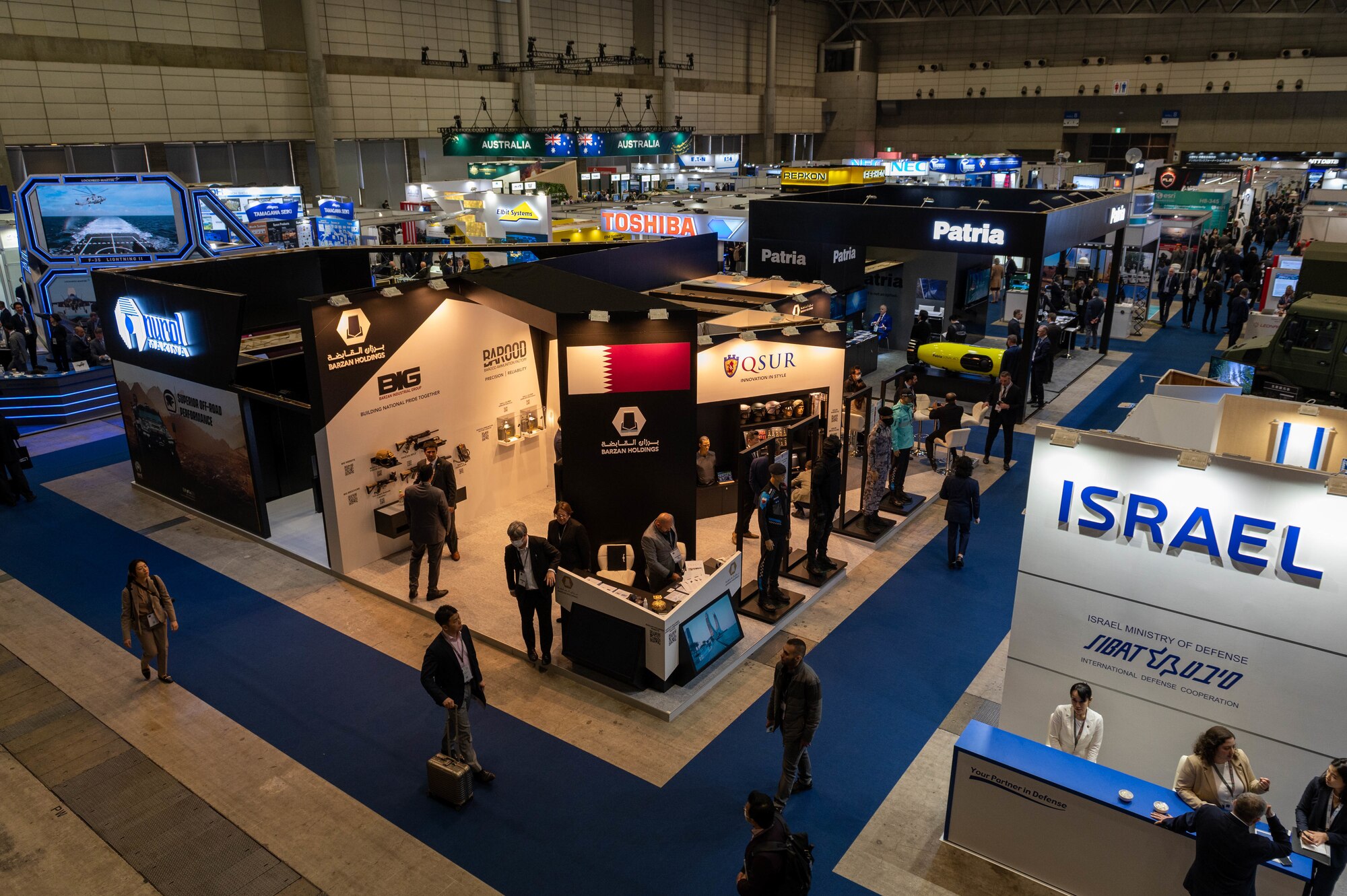 Companies exhibit technology products in a large convention center.