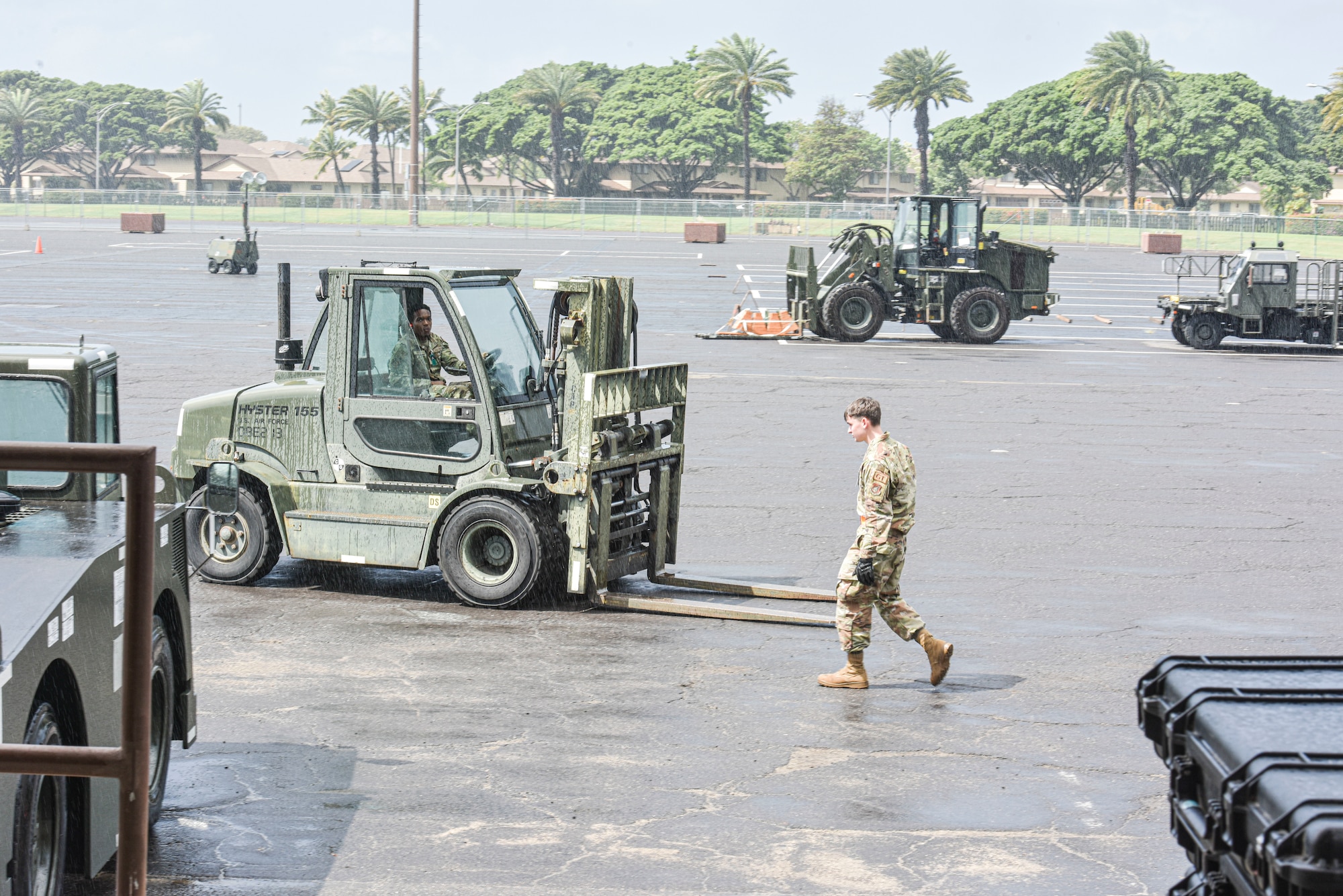 Airmen assigned to the 647th Logistics Readiness Squadron prepare the grounds for arrival of cargo  at Joint Base Pearl Harbor-Hickam, Hawaii, during the Joint Base Readiness Exercise, Feb. 28, 2023. JBRE is the wing’s annual exercise designed to demonstrate Hickam’s capability to deploy wing and tenant unit assets in support of USINDOPACOM operations. (U.S. Air Force photo by Tech. Sgt. Anthony Nelson Jr.)
