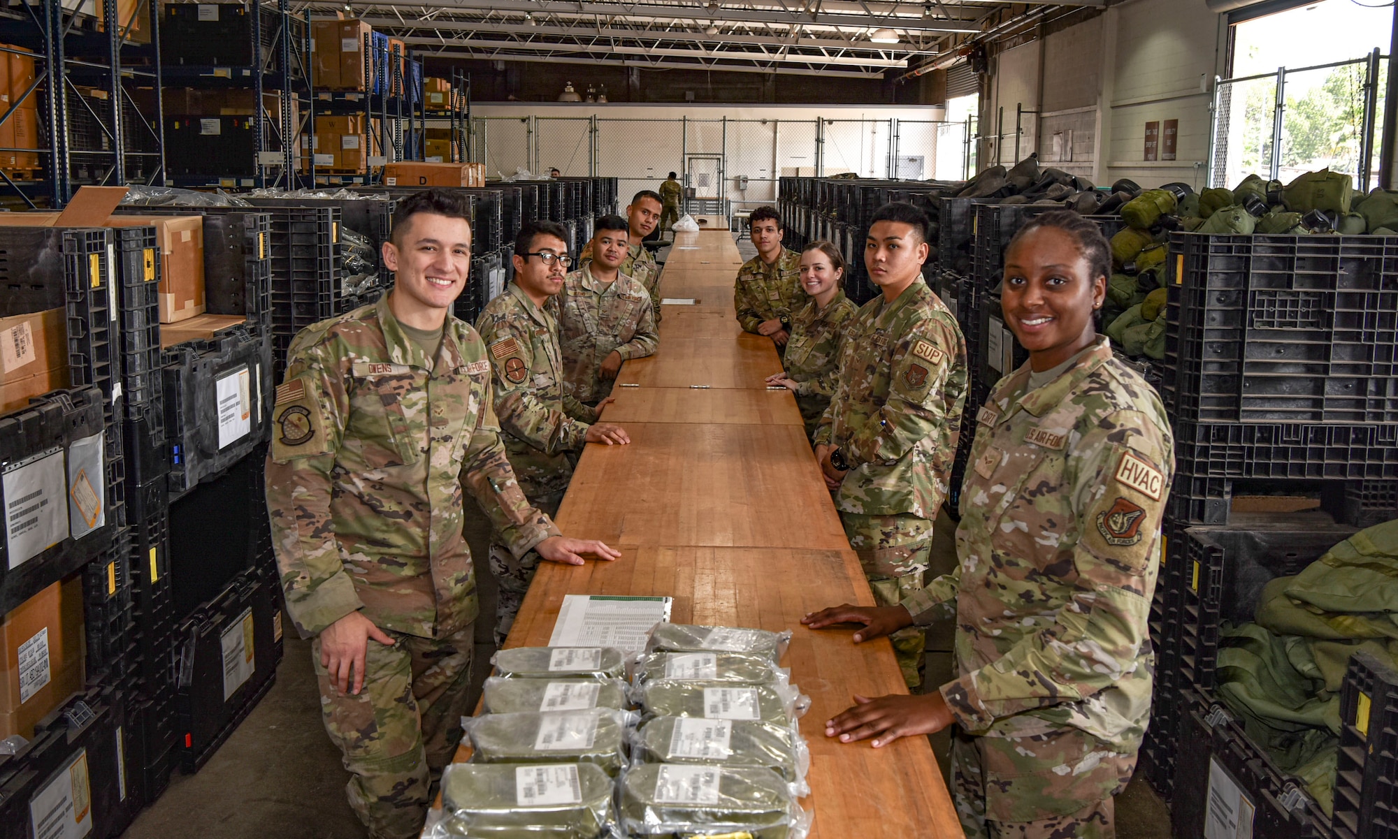 Airmen assigned to 15th Wing and 647th Air Base Group pose for a group photo after processing airmen and wing assets through a mobility pre-deployment function line at Joint Base Pearl Harbor-Hickam, Hawaii, during the Joint Base Readiness Exercise, Feb. 28, 2023. The 15th Wing’s ability to surge combat-ready forces across the theater is critical to supporting regional alliances, partnerships and stability.  (U.S. Air Force photo by Tech. Sgt. Anthony Nelson Jr.)