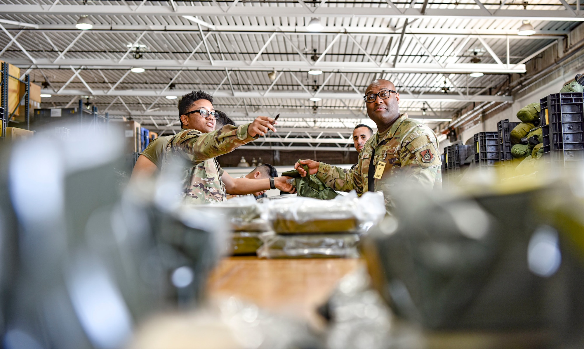 Airman 1st Class Kapri Robinson, 15th Operations Support Squadron exercise augmentee, directs airmen to the next section of the mobility line at Joint Base Pearl Harbor-Hickam, Hawaii, during the Joint Base Readiness Exercise, Feb. 28, 2023. The 15th Wing’s ability to surge combat-ready forces across the theater is critical to supporting regional alliances, partnerships and stability.  (U.S. Air Force photo by Tech. Sgt. Anthony Nelson Jr.)