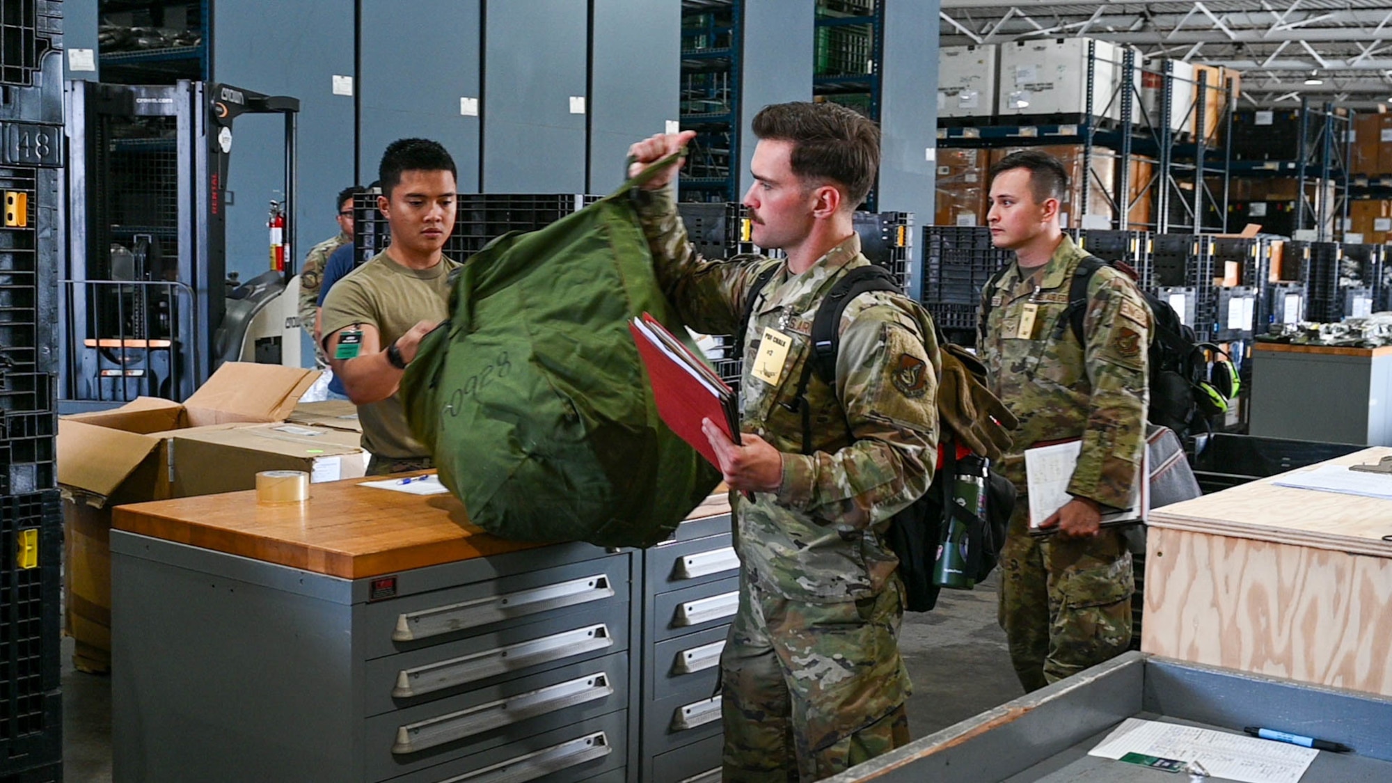 Airmen from the 15th Wing and 647th Air Base Group process through the mobility pre-deployment function line at Joint Base Pearl Harbor-Hickam, Hawaii, during the Joint Base Readiness Exercise, Feb. 28, 2022. The 15th Wing’s ability to surge combat-ready forces across the theater is critical to supporting regional alliances, partnerships and stability.  (U.S. Air Force photo by Senior Airman Makensie Cooper)