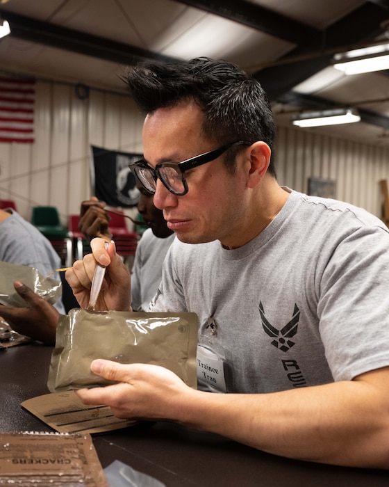 Trainee Tam Tran, 934th Airlift Wing Development and Training Flight trainee, inspects the contents of his meal ready-to-eat at the D&TF building at the Minneapolis-St. Paul Air Reserve Station, Minnesota, March 5, 2023. After completing his initial entry training, Tran will join the 934th Aeromedical Evacuation Squadron. (U.S. Air Force photo by Senior Airman Victoriya Tarakanova)