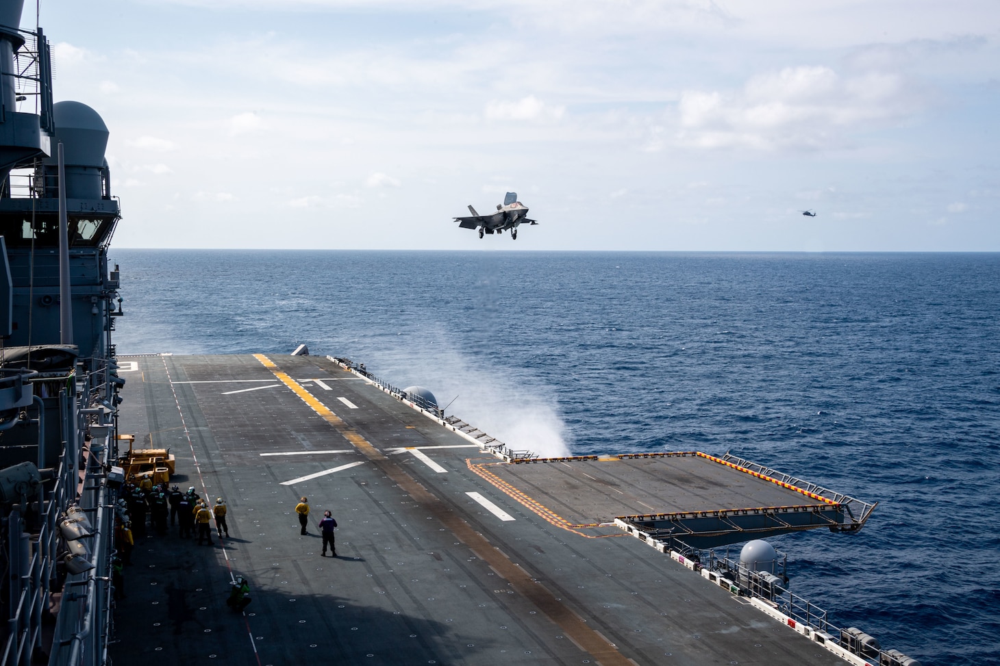 An F-35B Lightning II, assigned to Marine Fighter Attack Squadron (VMFA) 122, 13th Marine Expeditionary Unit, embarked aboard the Makin Island Amphibious Ready Group prepares to land on the flight deck of the forward-deployed amphibious assault ship USS America (LHA 6) during forward arming and refueling ship (FARS) operations while sailing in the East China Sea.