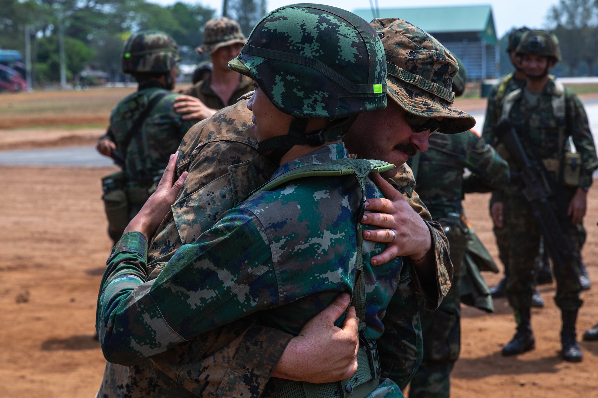 U.S. Marines with 1st Battalion, 7th Marines, and Royal Thai Marines with 2nd Battalion, 1st Infantry Regiment, exchange gifts and say goodbye after training together during Exercise Cobra Gold at Chanthaburi Province, Kingdom of Thailand, March 3, 2023