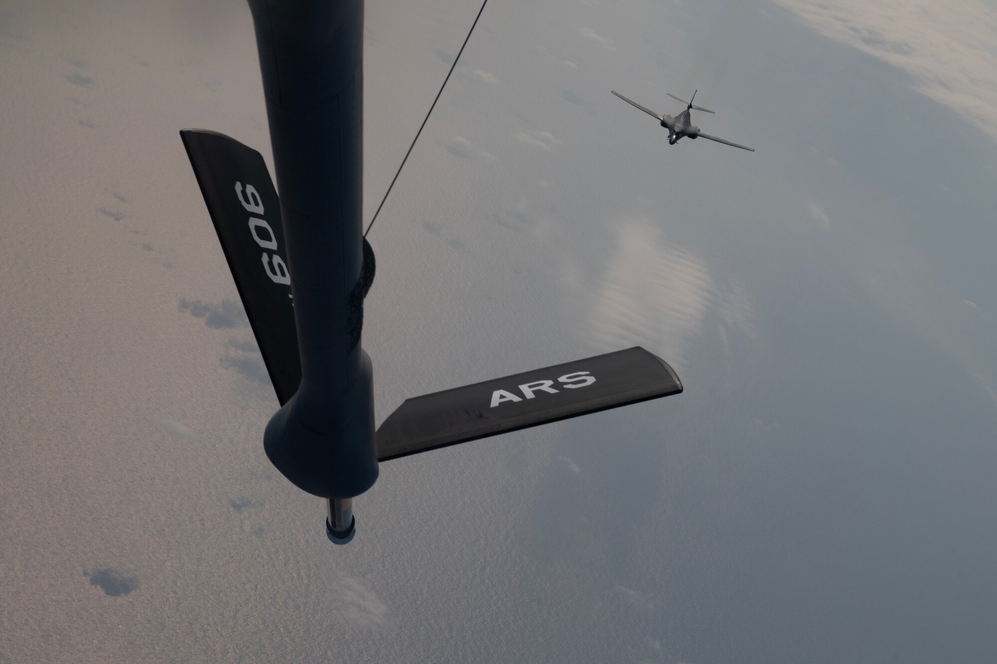 A U.S. Air Force 34th Expeditionary Bomb Squadron B-1B Lancer approaches a 909th Air Refueling Squadron KC-135 Stratotanker during a flight over the Pacific Ocean, March 19, 2023. Bomber missions contribute to joint force lethality and deter aggression in the Indo-Pacific by demonstrating the U.S. Air Force’s ability to operate anywhere in the world at any time in support of the National Defense Strategy. (U.S. Air Force photo by Senior Airman Jessi Roth)