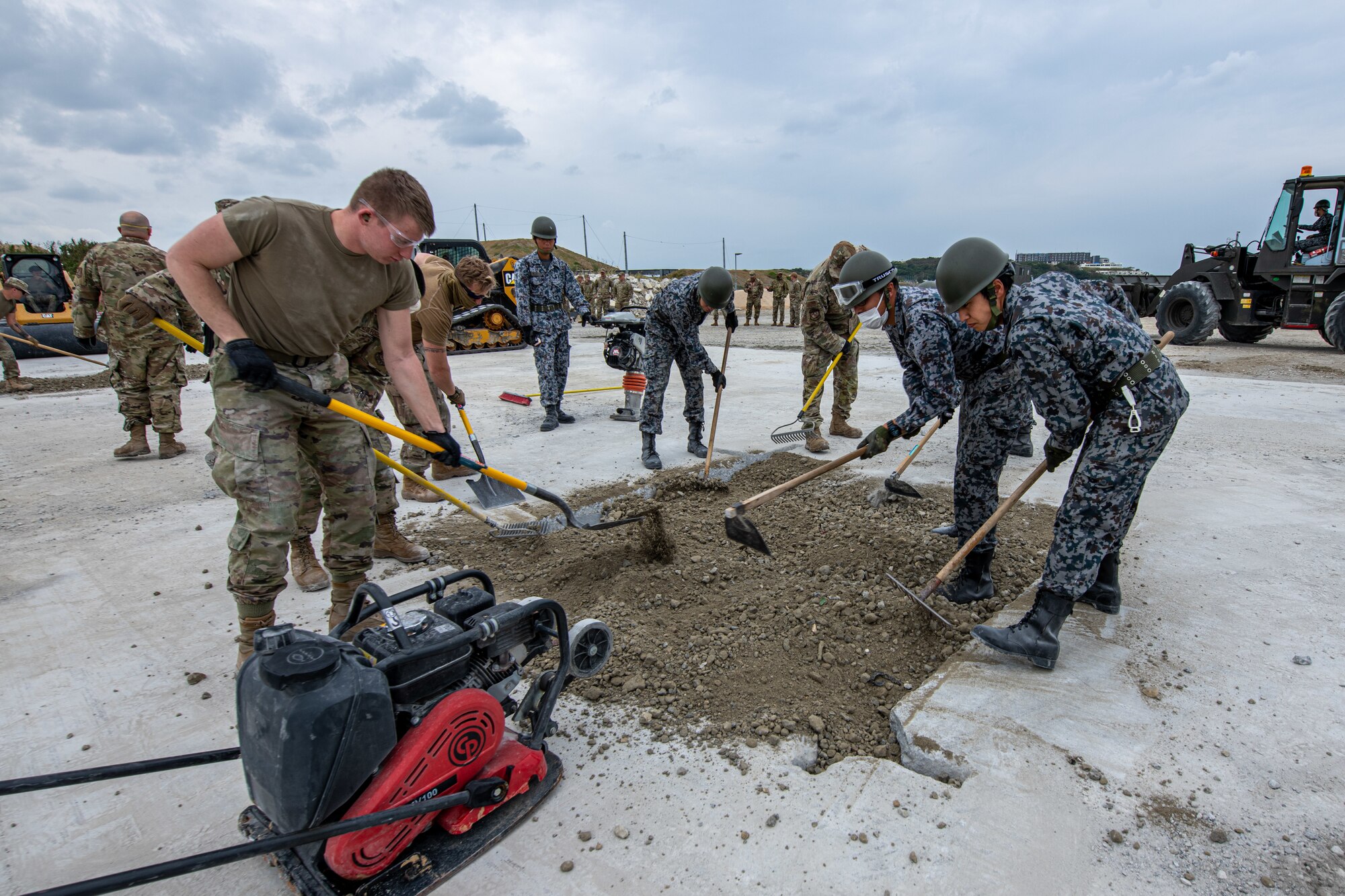 Airmen and allies prepare a dirt site.