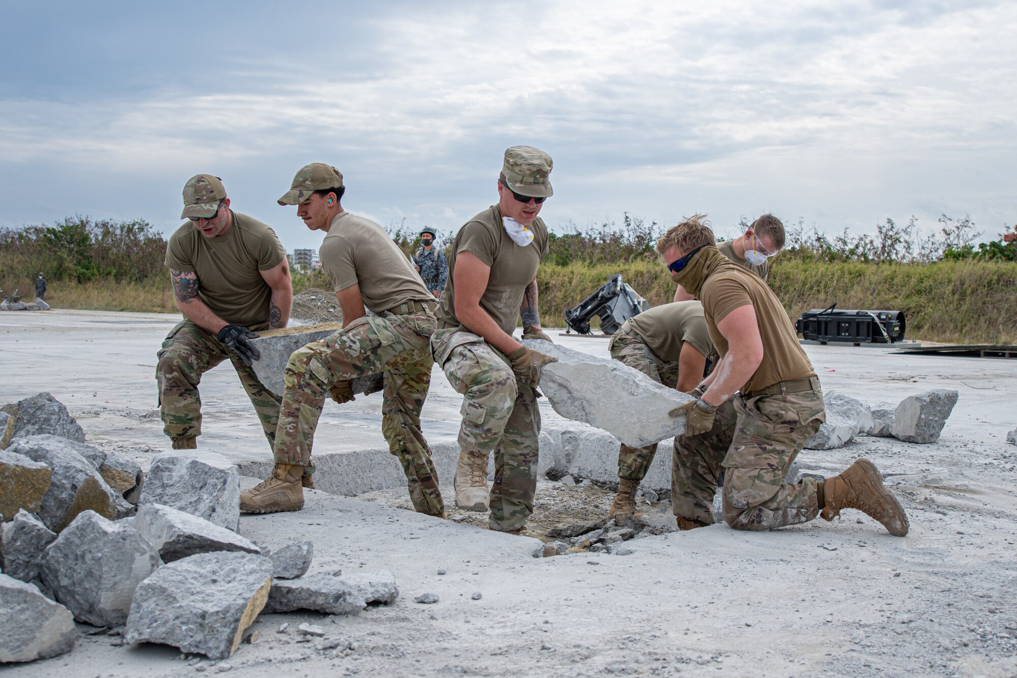 Airmen clear debris.