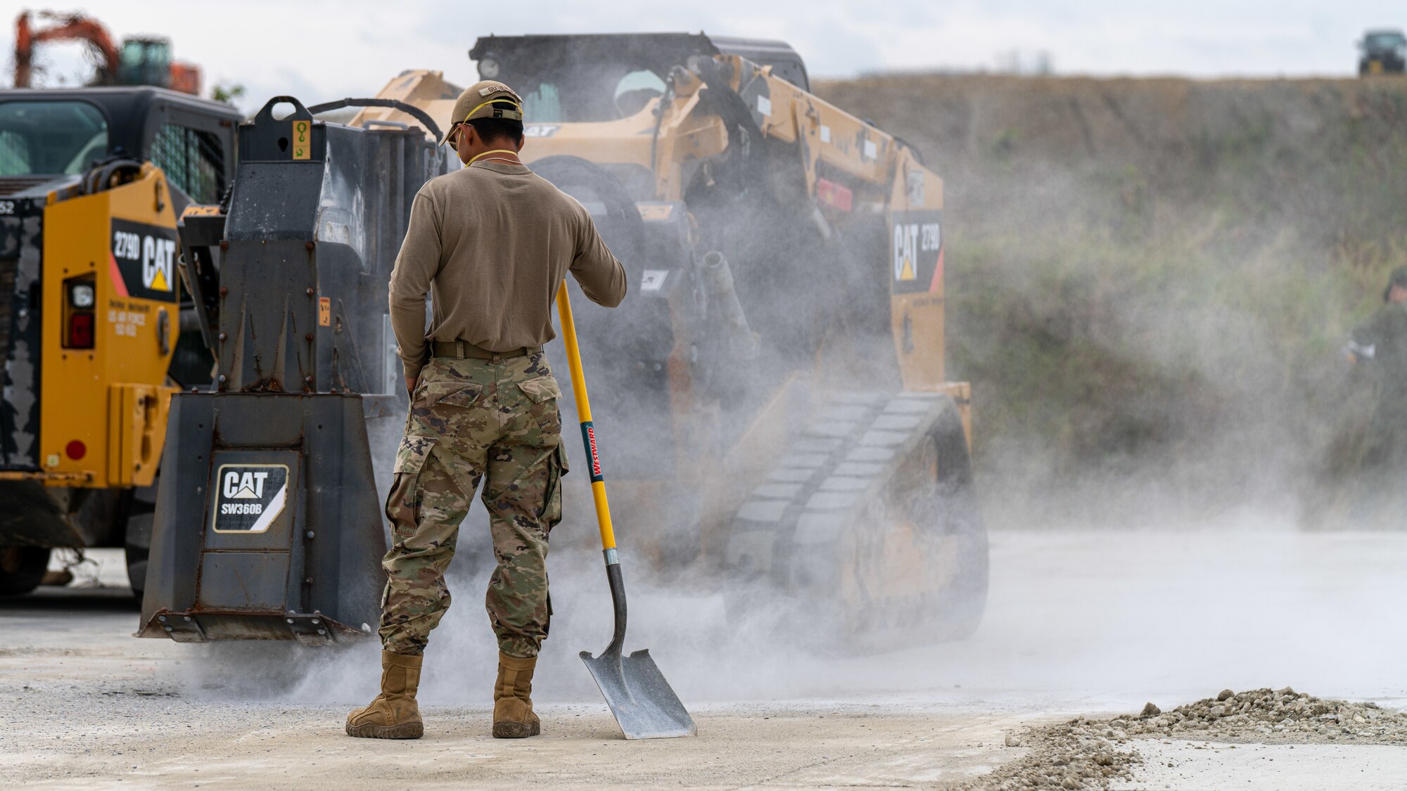 An Airman clears debris.