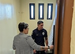 two people inspecting a confinement cell in Guam