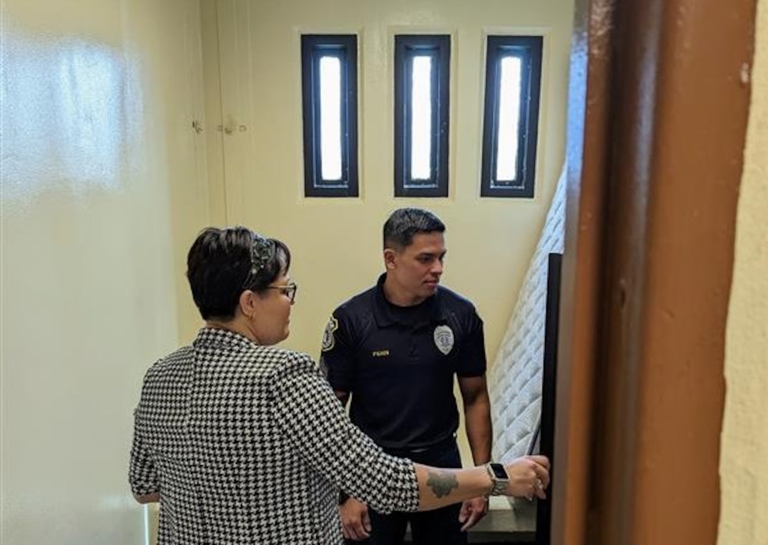 two people inspecting a confinement cell in Guam