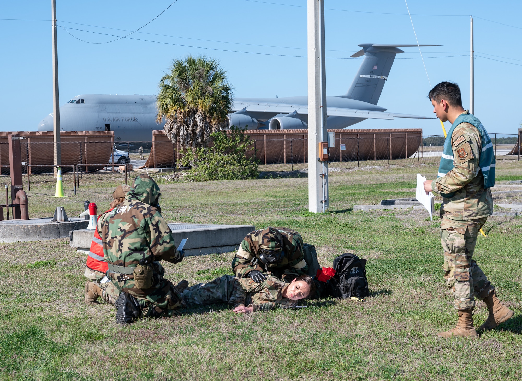 927th Mission Support Group Airmen perform tactical combat casualty care (TCCC) procedures on a simulated wounded service-member during an exercise on MacDill Air Force Base, Fla., Feb. 8, 2023. The exercise allowed Airmen to hone fundamental skills, such as TCCC, in a simulated contested environment, increasing overall readiness. (U.S. Air Force photo by Tech. Sgt. Bradley Tipton)