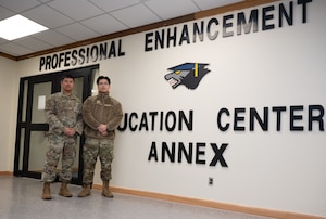 Master Sgt. Joseph Ryan Bonita (left), 8th Forces Support Squadron Kunsan development advisor, and Staff Sgt. Edward Kim, 8th FSS First Term Airman Course NCO in charge, take a photo in front of the Professional Enhancement Center annex at Kunsan Air Base, Republic of Korea, Mar. 16, 2023. Both work with several units to host professional development courses created to help benefit Airmen of all ranks in their careers. (U.S. Air Force photo by Staff Sgt. Sadie Colbert)