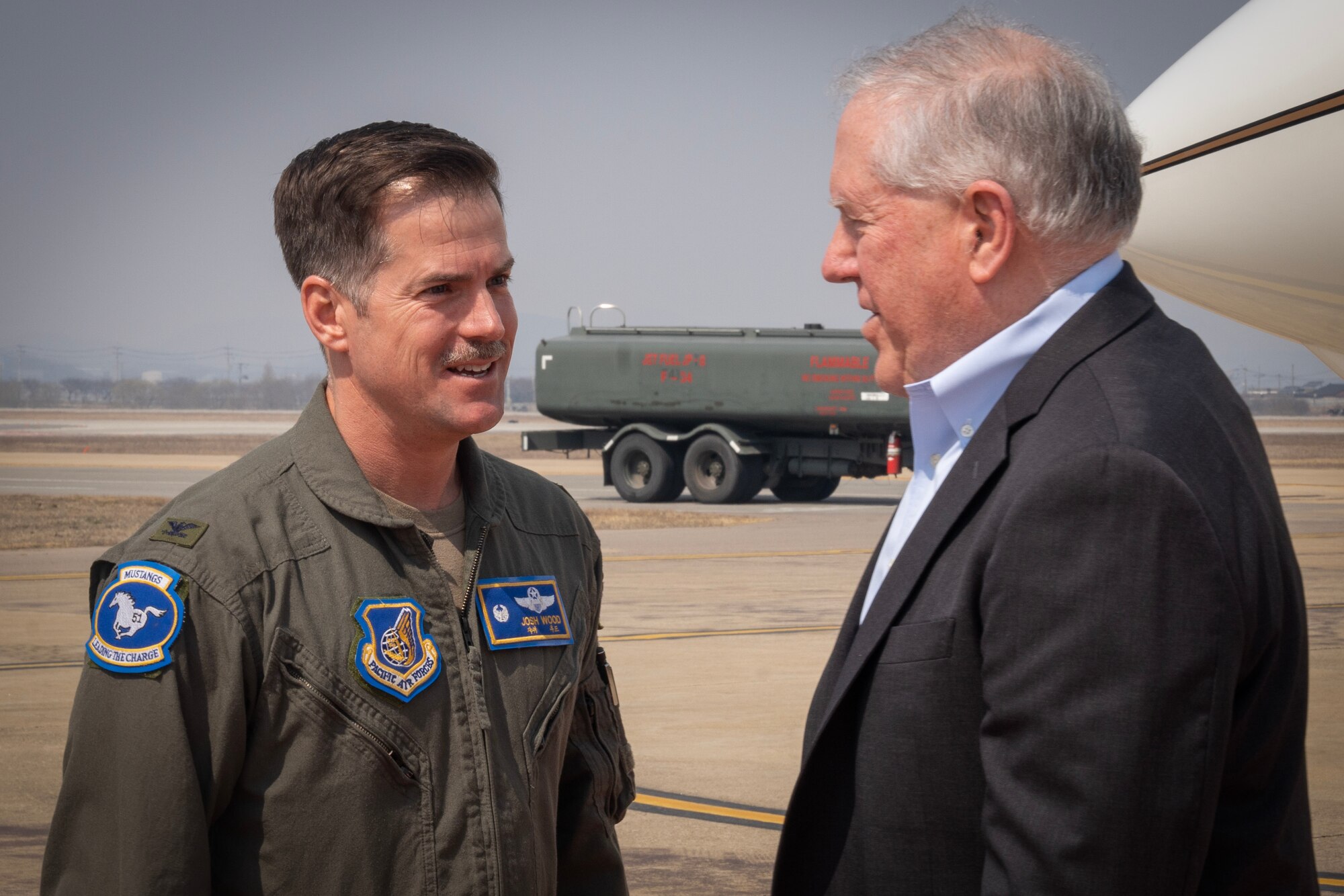 U.S. Air Force Col. Joshua Wood, 51st Fighter Wing commander, greets Secretary of the Air Force Frank Kendall after his arrival to Osan Air Base, Republic of Korea, on March 19, 2023.