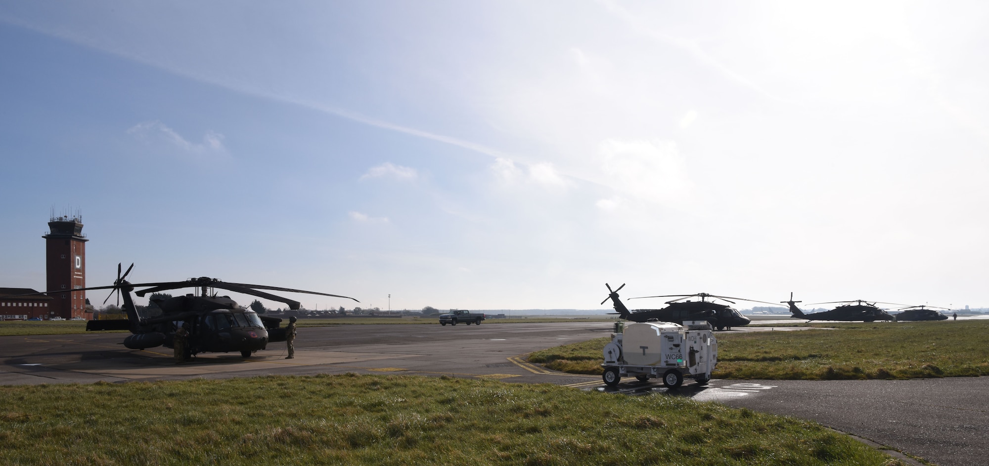 A U.S. Army UH-60M Black Hawk from the 1st Battalion, 214th Aviation Regiment (General Support Aviation Battalion), Wiesbaden, Germany, sits on the flightline as its maintainers and aircrew prep it for takeoff at Royal Air Force Mildenhall, England, March 15, 2023. The helicopters stopped off for refueling and rest before heading to RAF Leeming, Scotland. (U.S. Air Force photo by Karen Abeyasekere)