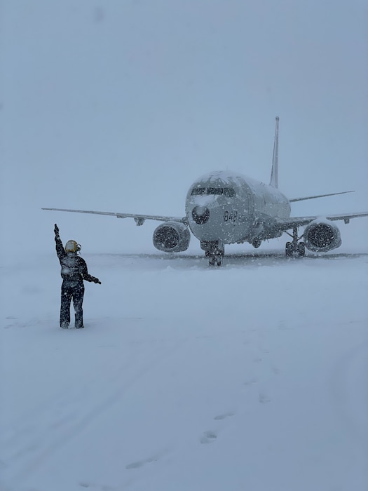 VP-45 aircraft being directed on a snow-covered flightline