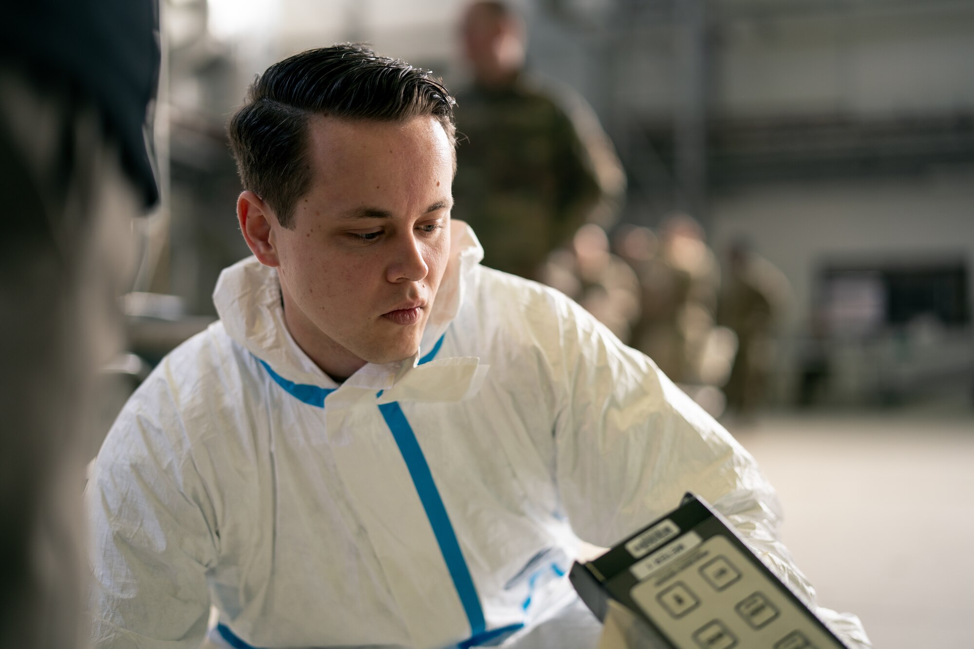 U.S. Air Force Staff Sgt. Colin Wyant, 786th Civil Engineer Squadron emergency management journeyman, conducts a decontamination process during exercise Radiant Falcon at Ramstein Air Base, Germany, March 16, 2023.