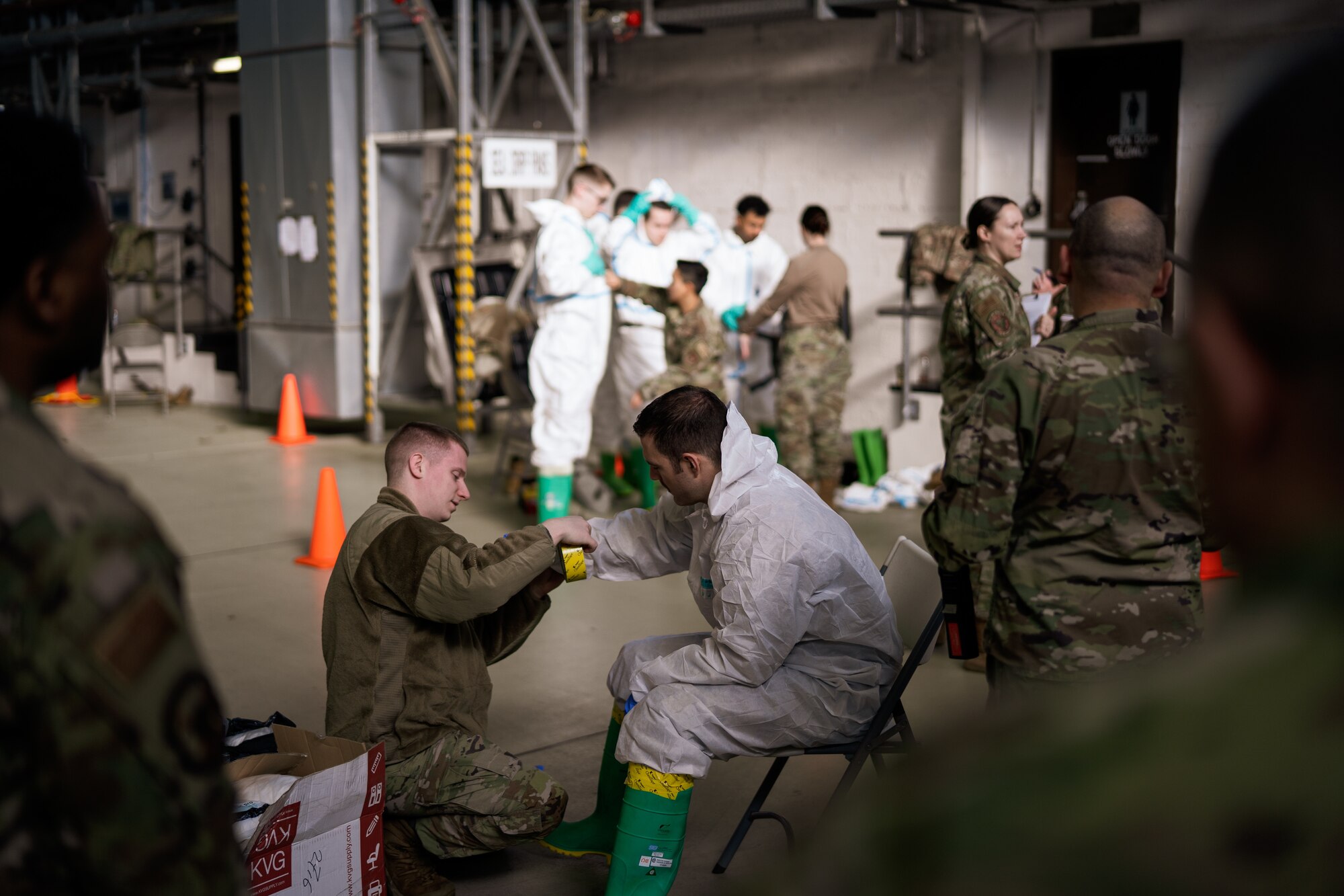 U.S. Air Force Airmen assigned to Ramstein Air Base put on protective gear during exercise Radiant Falcon at Ramstein AB, Germany, March 16, 2023.