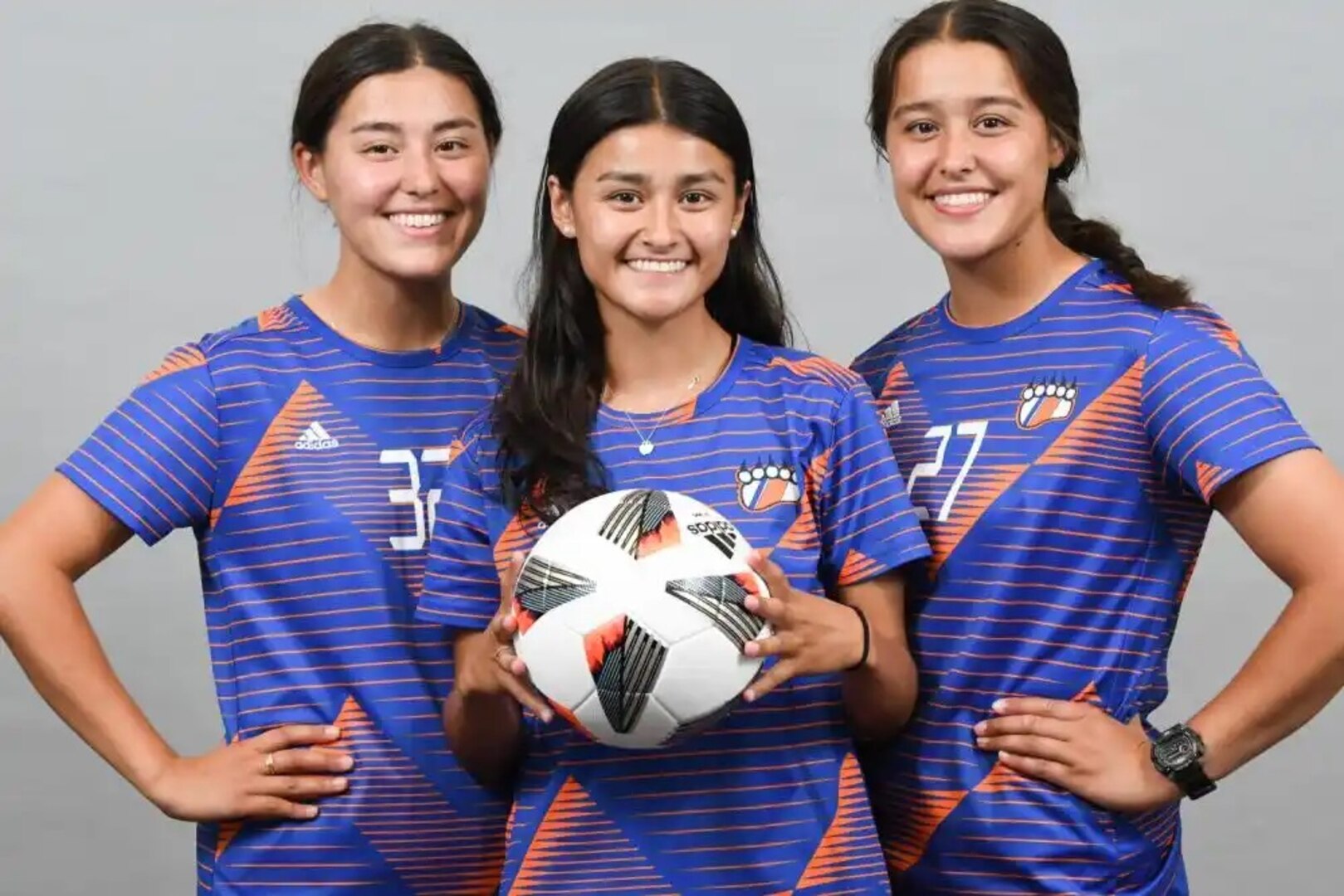 From left, Micki, Molly and Mary Kate Huynh, cadets at the Coast Guard Academy, pose for a group portrait in their soccer uniforms, here, Aug. 8, 2022. The teammates are also sisters in various years of cadet training. (U.S. Coast Guard courtesy photo by Bradley E. Clift)