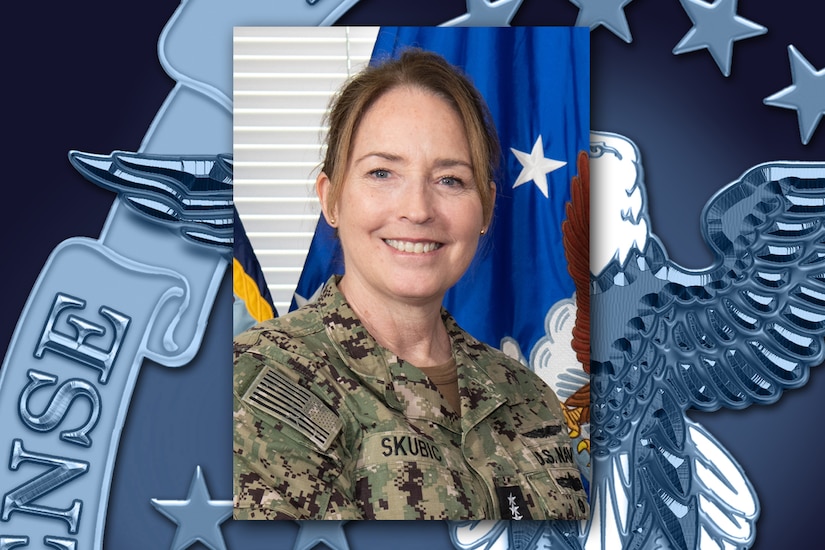 A uniformed service member smiles while getting new rank insignia pinned on her uniform.