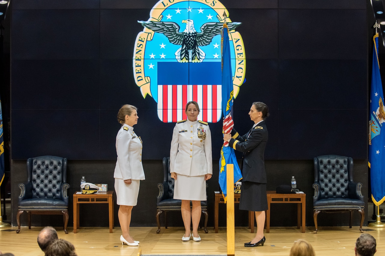 A uniformed service member assumes command from her predecessor during a ceremony.