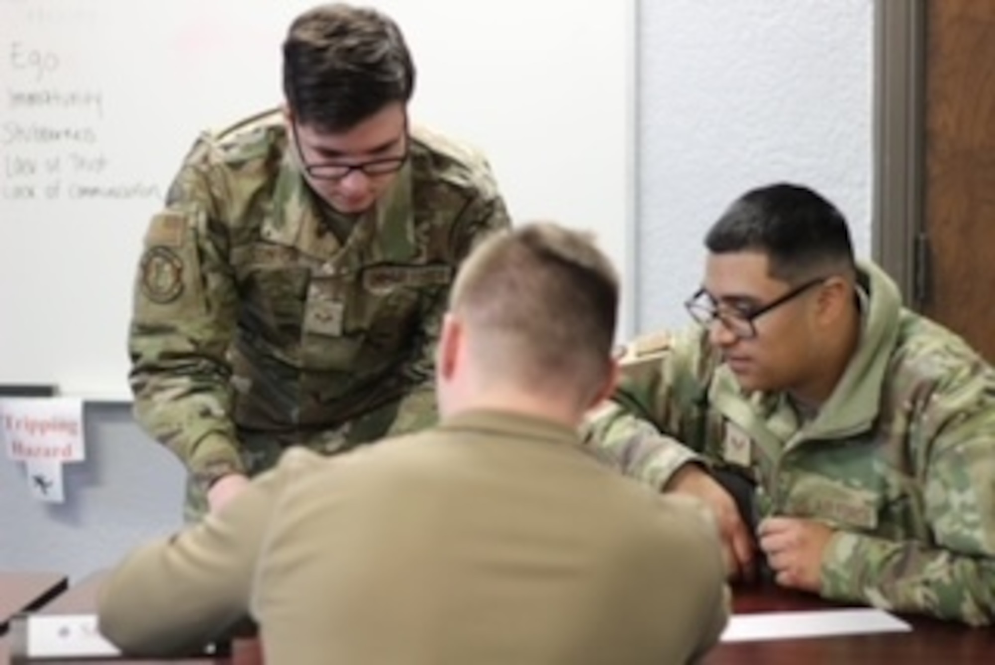 U.S. Air Force Senior Airmen Max Conner, Chandler Collins and Luis Mora, Airman Leadership School (ALS) students, participate in a team building exercise at Altus Air Force Base, Oklahoma, Jan. 25, 2023. ALS is designed to develop senior Airmen and staff sergeants as they prepare to take on supervisory roles. (courtesy photo by Senior Airman Adrian Stoudmire)