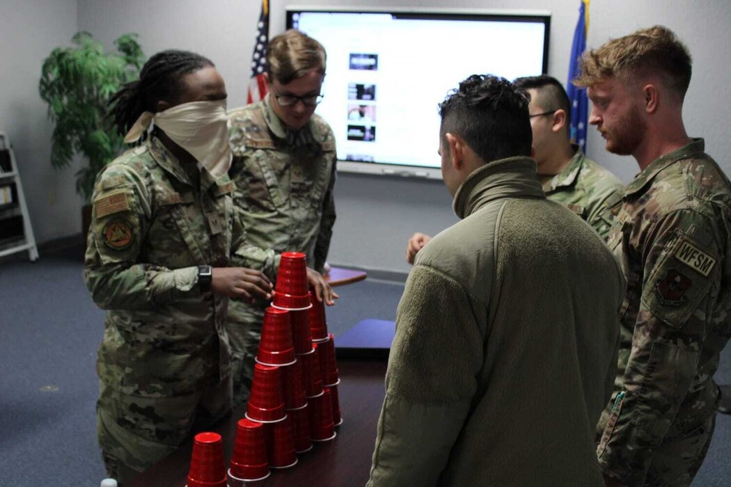 Airmen from Altus Air Force Base’s Airman Leadership School (ALS) participate in a team building exercise at Altus Air Force Base, Oklahoma, Jan. 25, 2023. The intent of the exercise was to guide blindfolded Airmen in building a tower by using effective communication. (courtesy photo by Senior Airman Adrian Stoudmire)