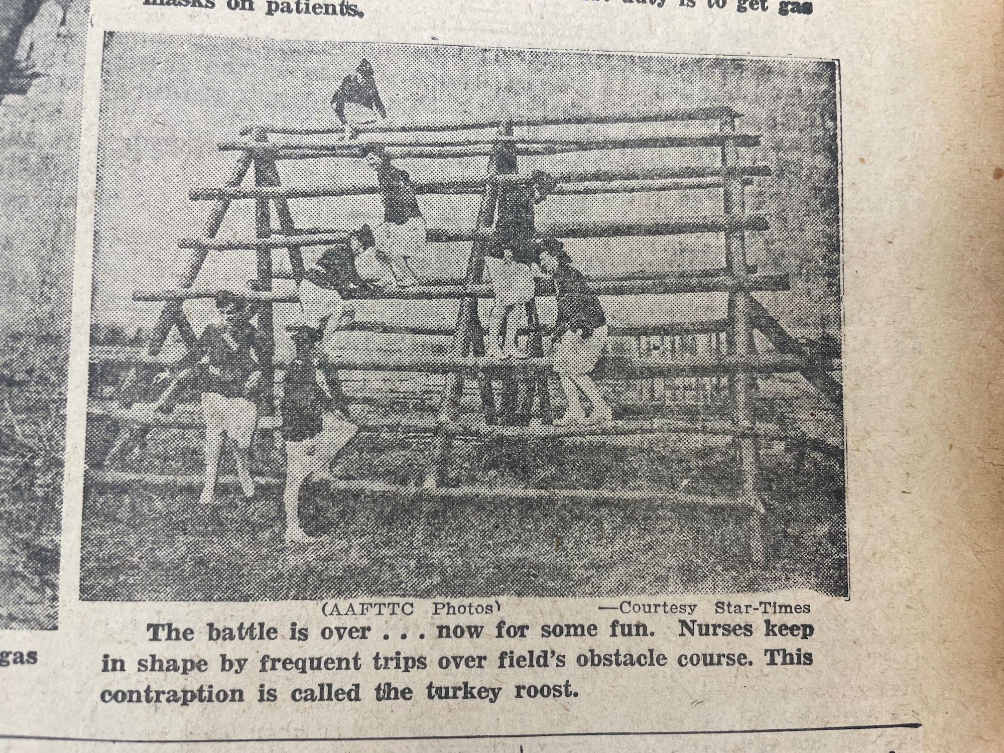 A newspaper clipping depicting Scott Field’s Army nurses climbing over an obstacle in their obstacle course, Dec. 23, 1942 on Scott Air Force Base, Illinois. (DoD photo by 1942 Scott AFB History)