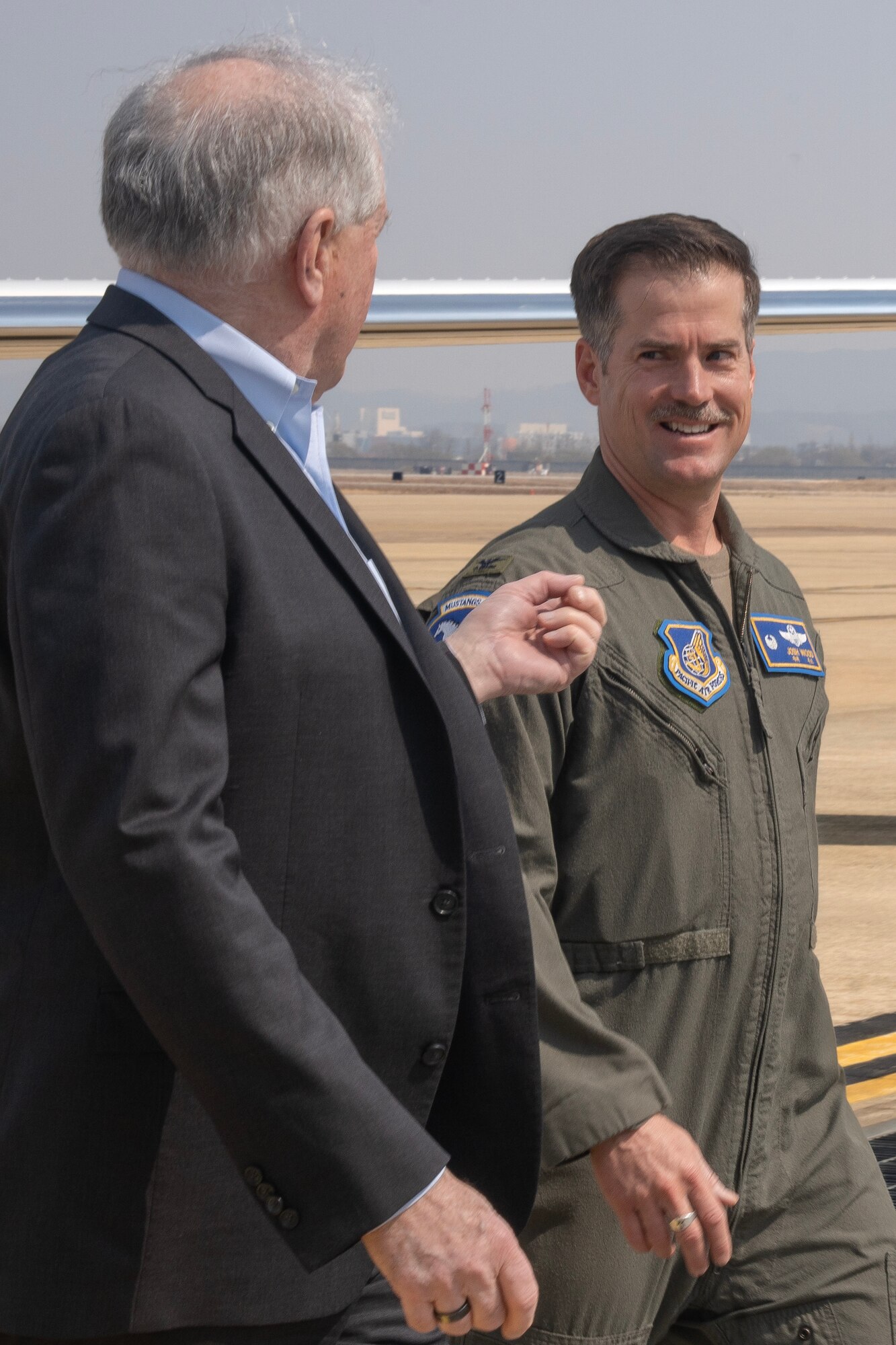 Secretary of the Air Force Frank Kendall (Left) speaks with U.S. Air Force Col. Joshua Wood, 51st Fighter Wing commander, after his arrival to Osan Air Base, Republic of Korea, on March 19, 2023.
