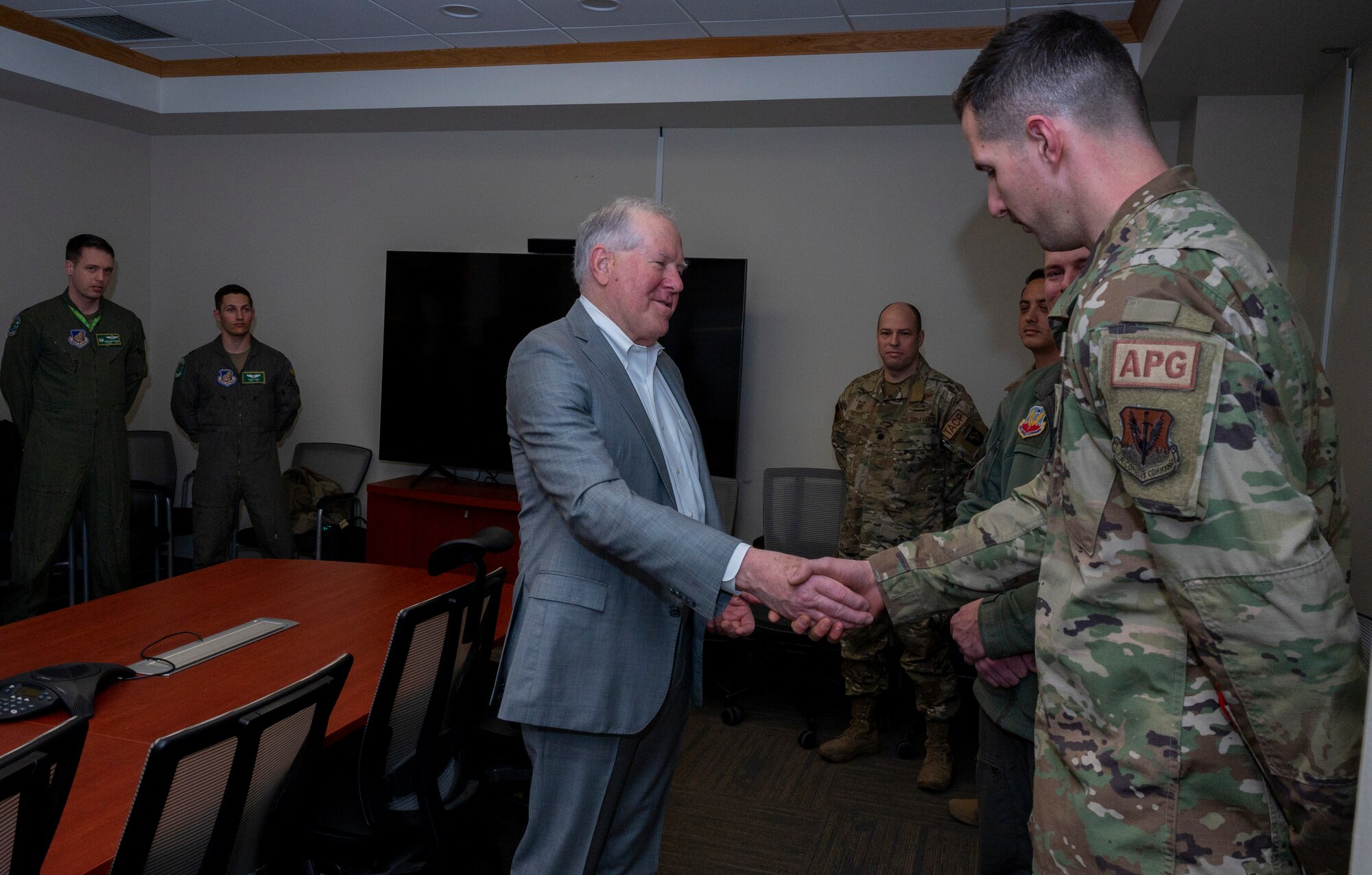 Secretary of the Air Force Frank Kendall coins Tech. Sgt. William Simmons, 5th Reconnaissance Squadron aircraft section chief, during his immersion tour at Osan Air Base, Republic of Korea, March 20, 2023.