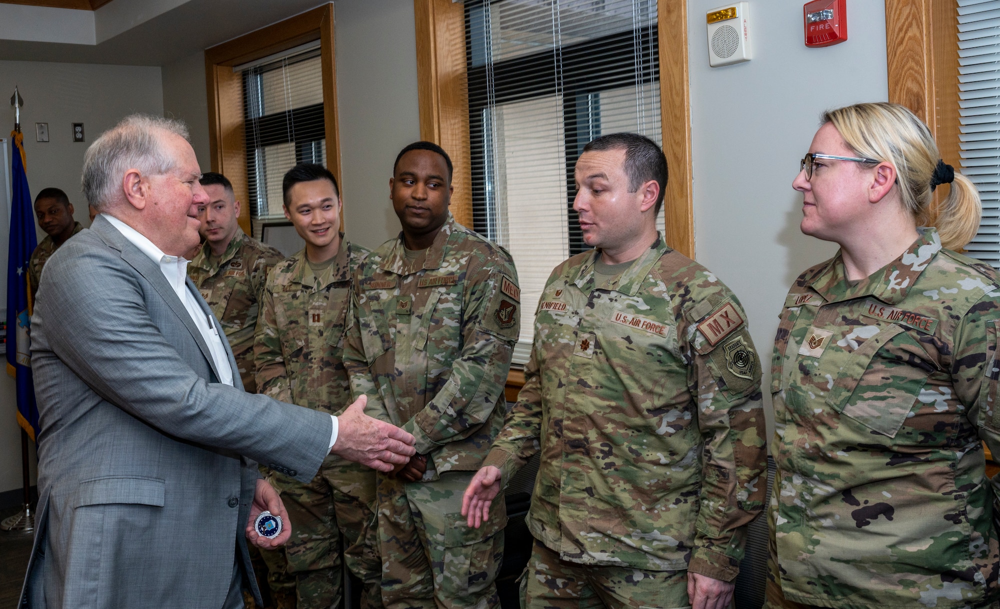 Secretary of the Air Force Frank Kendall coins Airmen assigned to the 51st Fighter Wing at Osan Air Base, Republic of Korea, March 20, 2023.