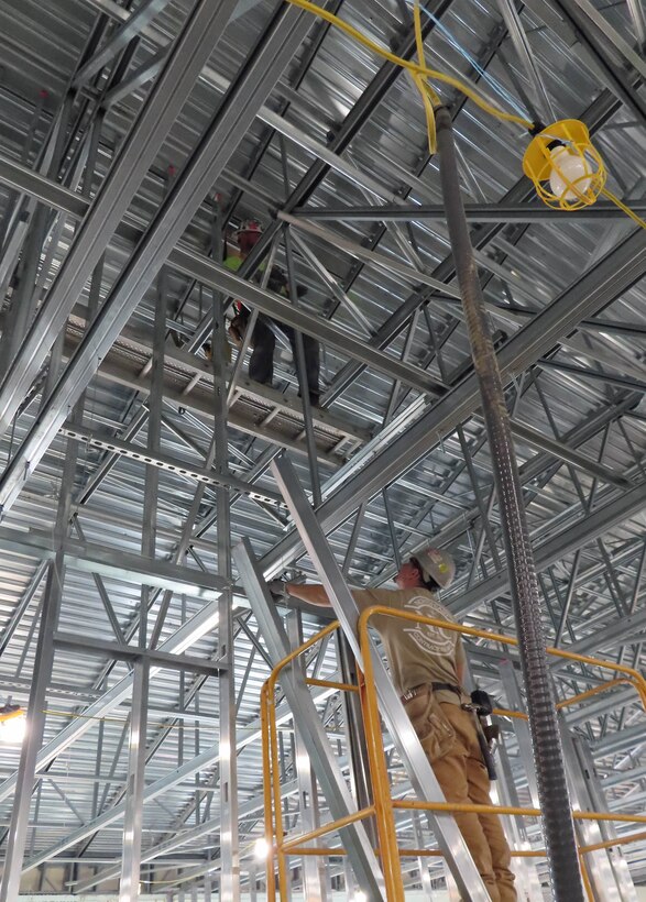 Photo shows steel structure being erected