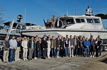 Rep. Jennifer Kiggans (R-Va.) and Rep. Brad Finstad (R-Minn.) pose for a photo aboard a security boat attached to Maritime Expeditionary Security Group 2, joined by 25 congressional staffers from 20 different offices who attended the Meet the Fleet program in Norfolk, Feb. 12 - 14. The Navy Office of Legislative Affairs executes Meet the Fleet to educate new Members of Congress on Navy operations and provide them a unique opportunity to visit bases to observe platforms and speak with Sailors.
