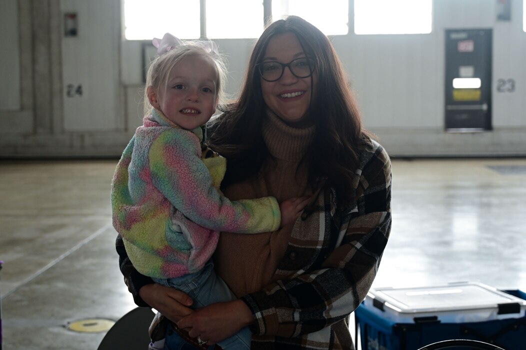 A woman and her toddler poses for a photo