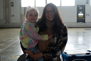 A woman and her toddler poses for a photo