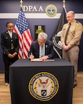 The Defense POW/MIA Accounting Agency Director (DPAA), Mr. Kelly McKeague (center) signs a framework arrangement with the Government of Indonesia on March 21, 2023, Arlington, Virginia. McKeague is joined by the DPAA Principal Deputy Director Ms. Fern Sumpter Winbush (left) and Senior Defense Official and Defense Attaché to Indonesia, U.S. Army Colonel Theodore Liebreich in this historic occasion. The framework permits the first DPAA joint research and survey mission later this year of Americans missing from World War II in Indonesia.