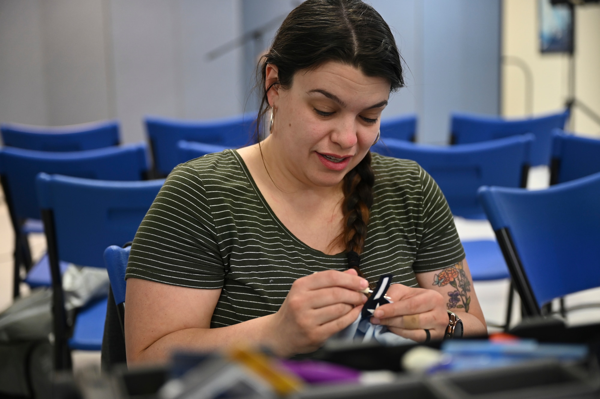 A woman sews a patch.