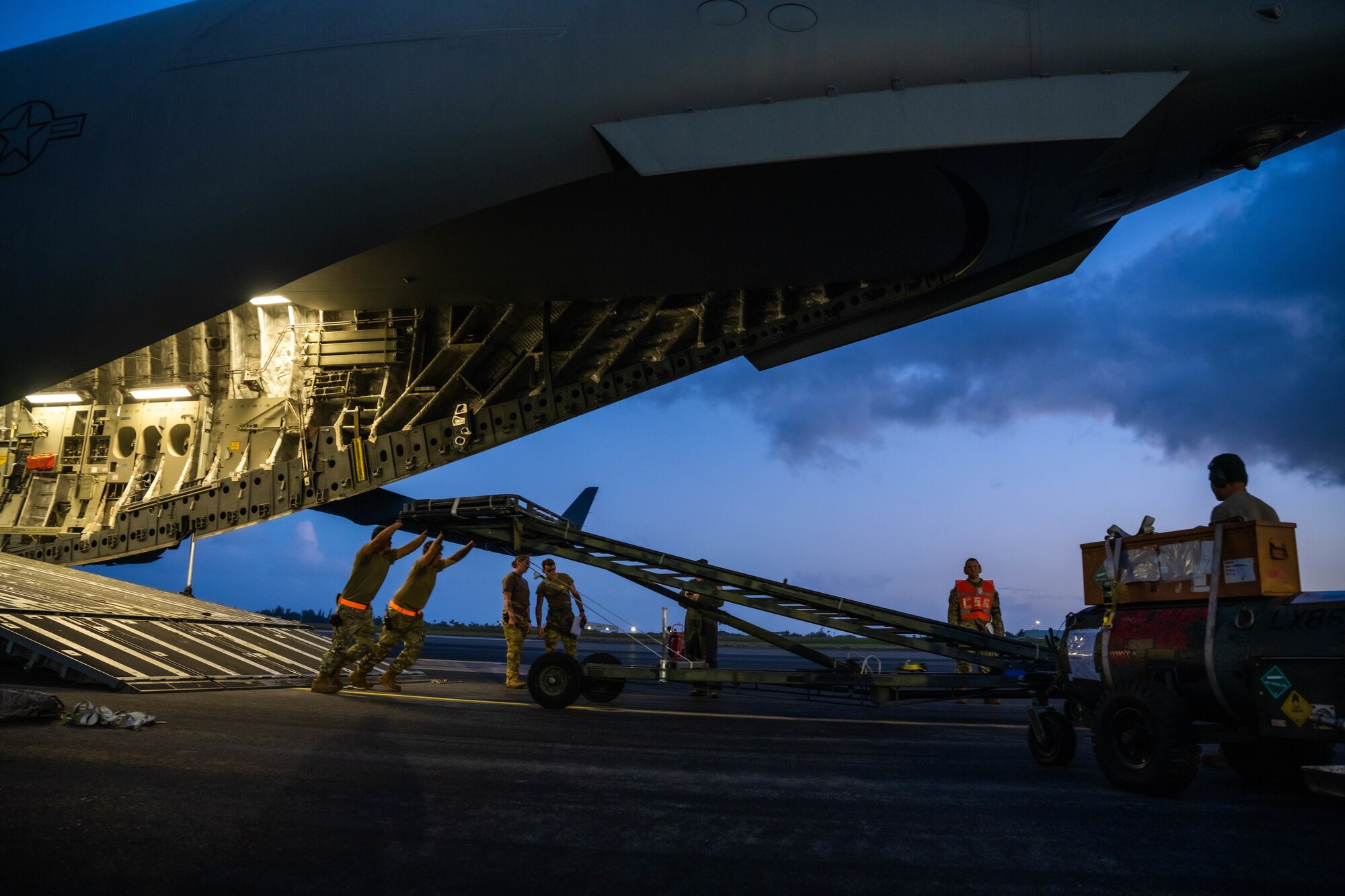 Airmen assigned to the 535th Airlift Squadron and the 735th Air Mobility Squadron load cargo on a C-17 Globemaster III at Joint Base Pearl Harbor-Hickam, Hawaii, during the Joint Base Readiness Exercise, March 1, 2023. The 15th Wing’s ability to surge combat-ready forces across the theater is critical to supporting regional alliances, partnerships and stability. (U.S. Air Force photo by Senior Airman Makensie Cooper)