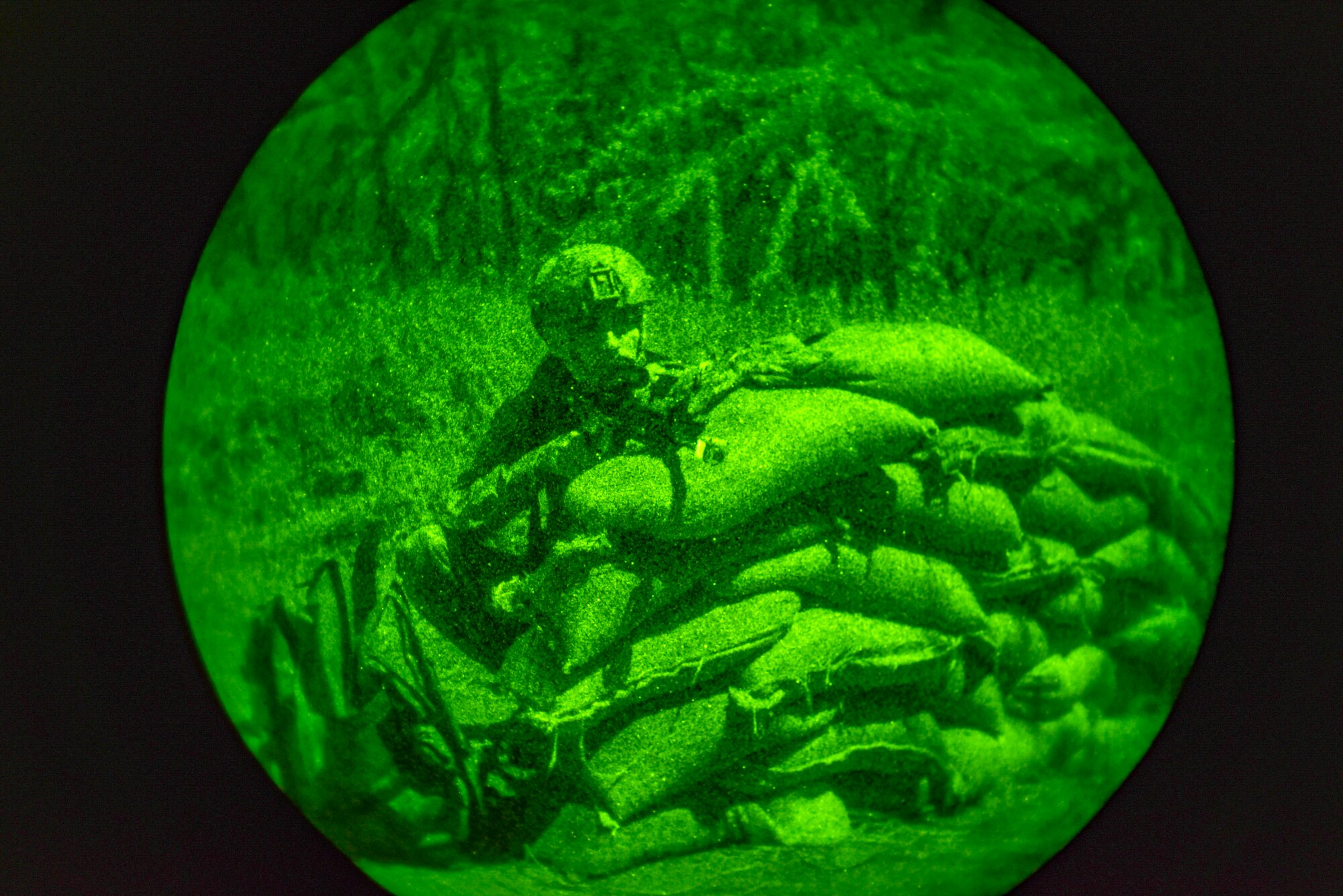 Airmen assigned to the 647th Security Forces Squadron defend their post during a small arms fire during a night mission at a forward operating base at Joint Base Pearl Harbor-Hickam, Hawaii, during the Joint Base Readiness Exercise, Mar. 6, 2023. JBRE provides realistic training in various operations, enabling our airmen to provide distinct tools and capabilities needed for mission success in an ever-changing area of responsibility. (U.S. Air Force photo by Tech. Sgt. Anthony Nelson Jr.)