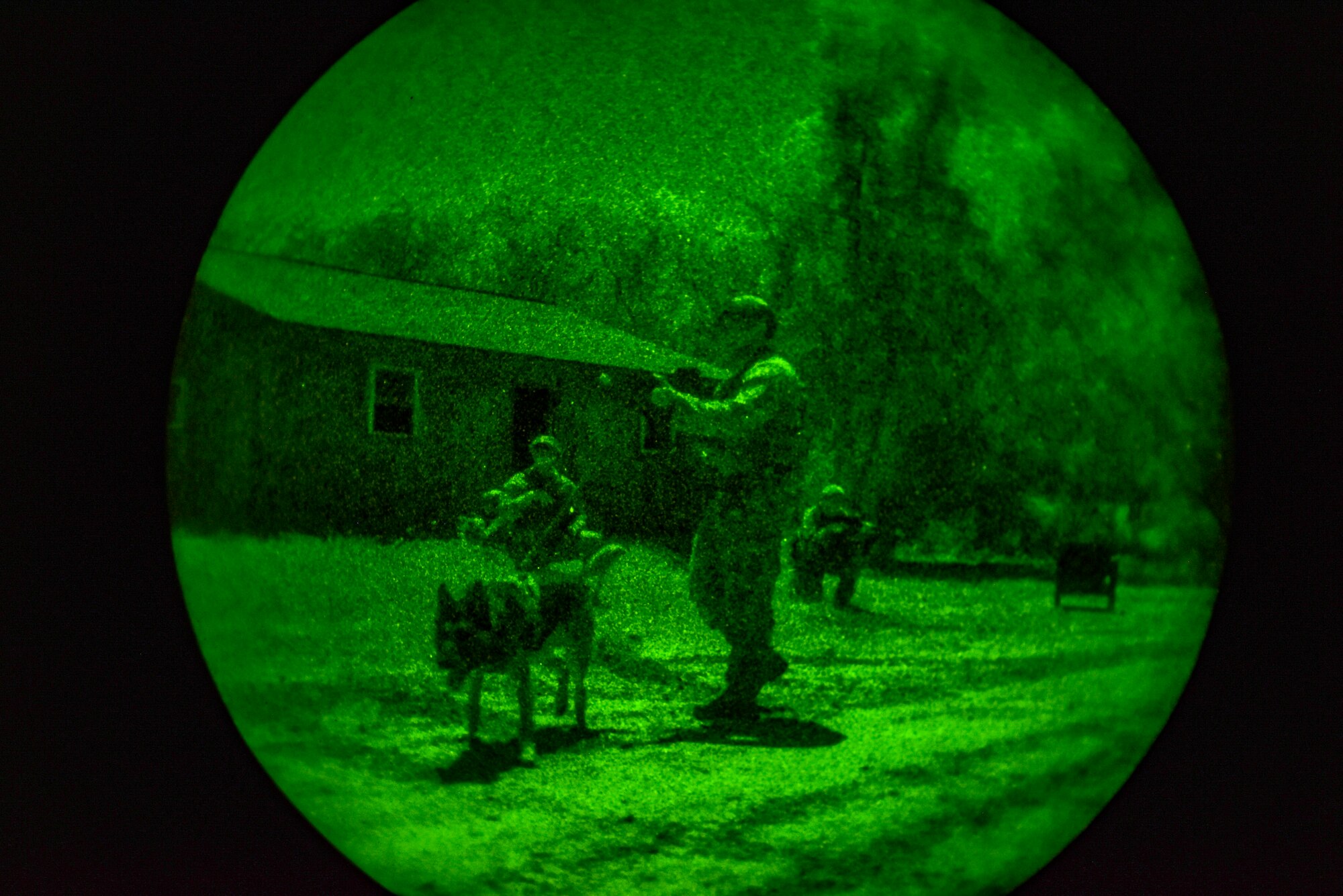 647th Security Forces Squadron Airmen quick reaction force team, clears buildings and assess personnel after a small arms fire during a night mission at a forward operating base at Joint Base Pearl Harbor-Hickam, Hawaii, during the Joint Base Readiness Exercise, Mar. 6, 2023. JBRE provides realistic training in various operations, enabling our airmen to provide distinct tools and capabilities needed for mission success in an ever-changing area of responsibility. (U.S. Air Force photo by Tech. Sgt. Anthony Nelson Jr.)
