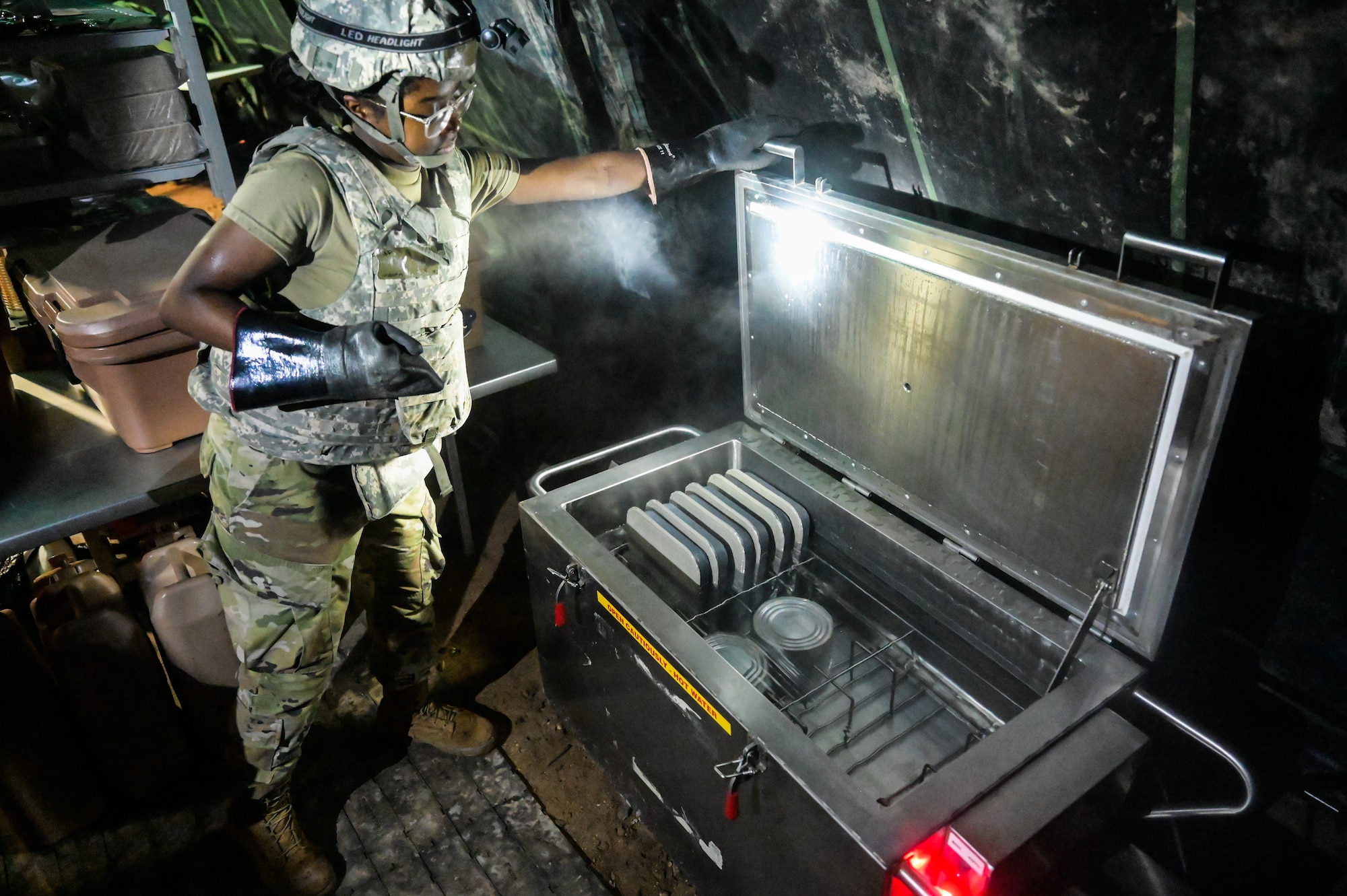 Airman 1st Class Teralynn Payton, 647th Force Support Squadron food service apprentice, prepares food during a Joint Base Readiness Exercise at Joint Base Pearl Harbor-Hickam, Hawaii, March. 7, 2023. JBRE provides realistic training in various operations, enabling our Airmen to provide distinct tools and capabilities needed for mission success in an ever-changing theater. (U.S. Air Force photo by Staff Sgt. Alan Ricker)