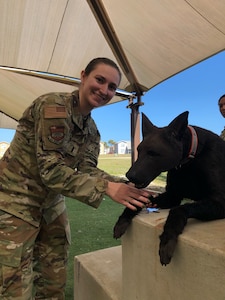1st Lt. Alexis Carlson, 932nd Medical Squadron, poses with a mannequin of a military working dog at the conclusion of a working dog training simulation Feb. 9, 2023 during Operation Joint Endeavour. In recognition of Women’s History Month, Carlson shared her perspective on serving as a woman in the military, the obstacles she has overcome, and her thoughts on the service's initiatives to achieve a rich, diverse and inclusive force.