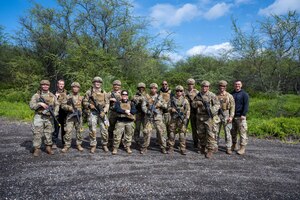 Members of the 647th Security Forces Squadron pose for a group photo after successfully completing a training exercise during Joint Base Readiness Exercise 23-01 at Joint Base Pearl Harbor-Hickam, Hawaii, March 8, 2023. JBRE 23-01 is the largest exercise the 15th Wing has executed in over a decade including over eight other participating units throughout the Pacific. (U.S. Air Force photo by SrA Makensie Cooper)