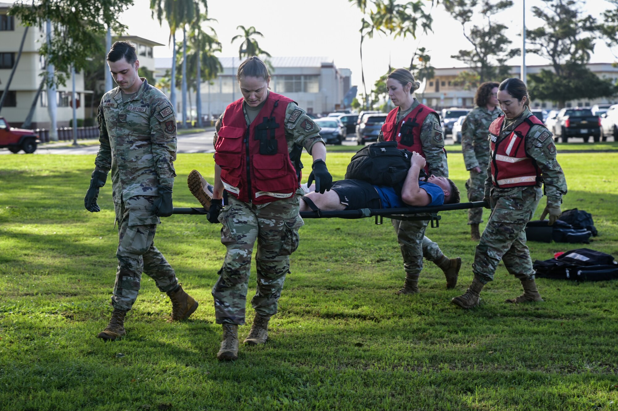 Airmen assigned to the 15th Medical Group carry a volunteer with simulated injuries on a litter during a Joint Base Readiness Exercise at Joint Base Pearl Harbor-Hickam, Hawaii, Mar. 8, 2023. Team Hickam trains to operate, fight, and advance its capabilities through realistic training exercises designed to test and develop joint logistics, resilience and rapid strategic mobility. (U.S. Air Force photo by Staff Sgt. Alan Ricker)