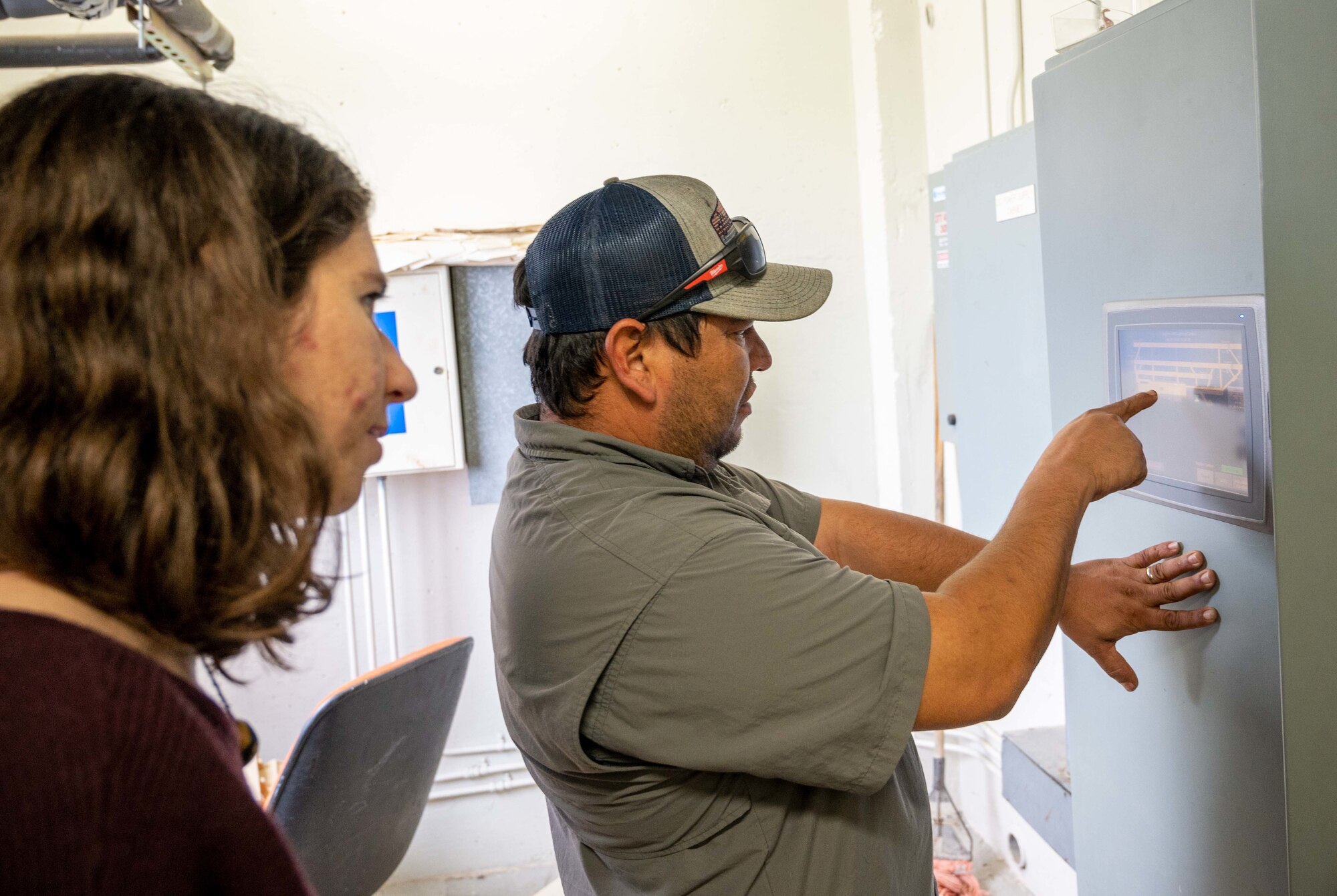 Caroline Easley, 47th Civil Engineering Squadron electrical engineer (left) listens as Daniel Montalvo, Project Superintendent for Laughlin's Airfield Lighting Modernization, as he explains what areas of the airfield will be effected by the changes on Dec 5, 2022. Laughlin's Airfield improvement and modernization will help keep workers and pilots safer while working on the electrical systems and while flying in the skies. (U.S. Air Force photo by Senior Airman Nicholas Larsen)