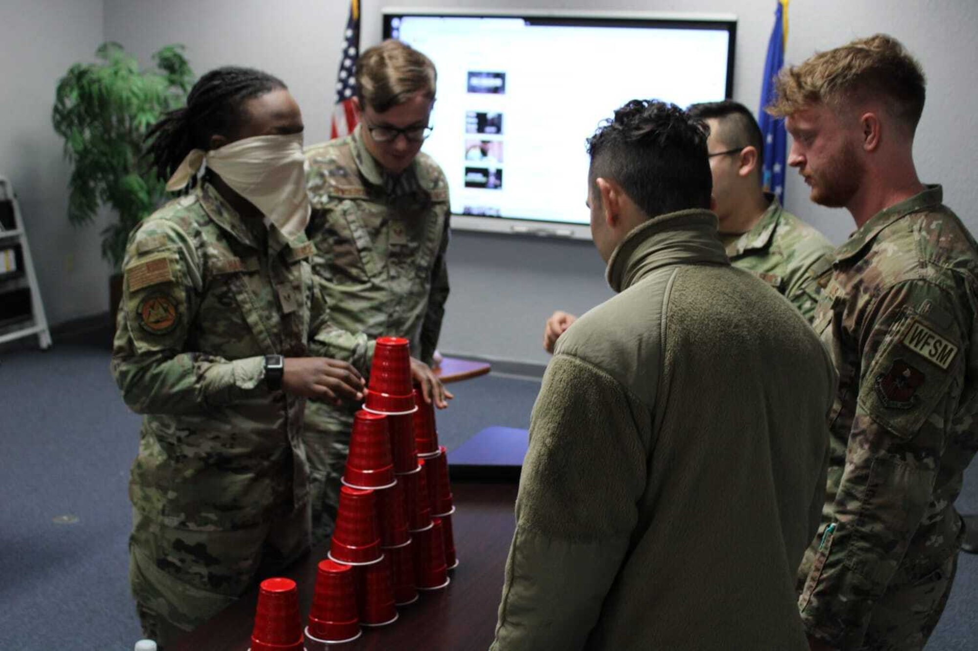 Airmen from Altus Air Force Base’s Airman Leadership School (ALS) participate in a team building exercise at Altus Air Force Base, Oklahoma, Jan. 25, 2023. The intent of the exercise was to guide blindfolded Airmen in building a tower by using effective communication. (courtesy photo by Senior Airman Adrian Stoudmire)