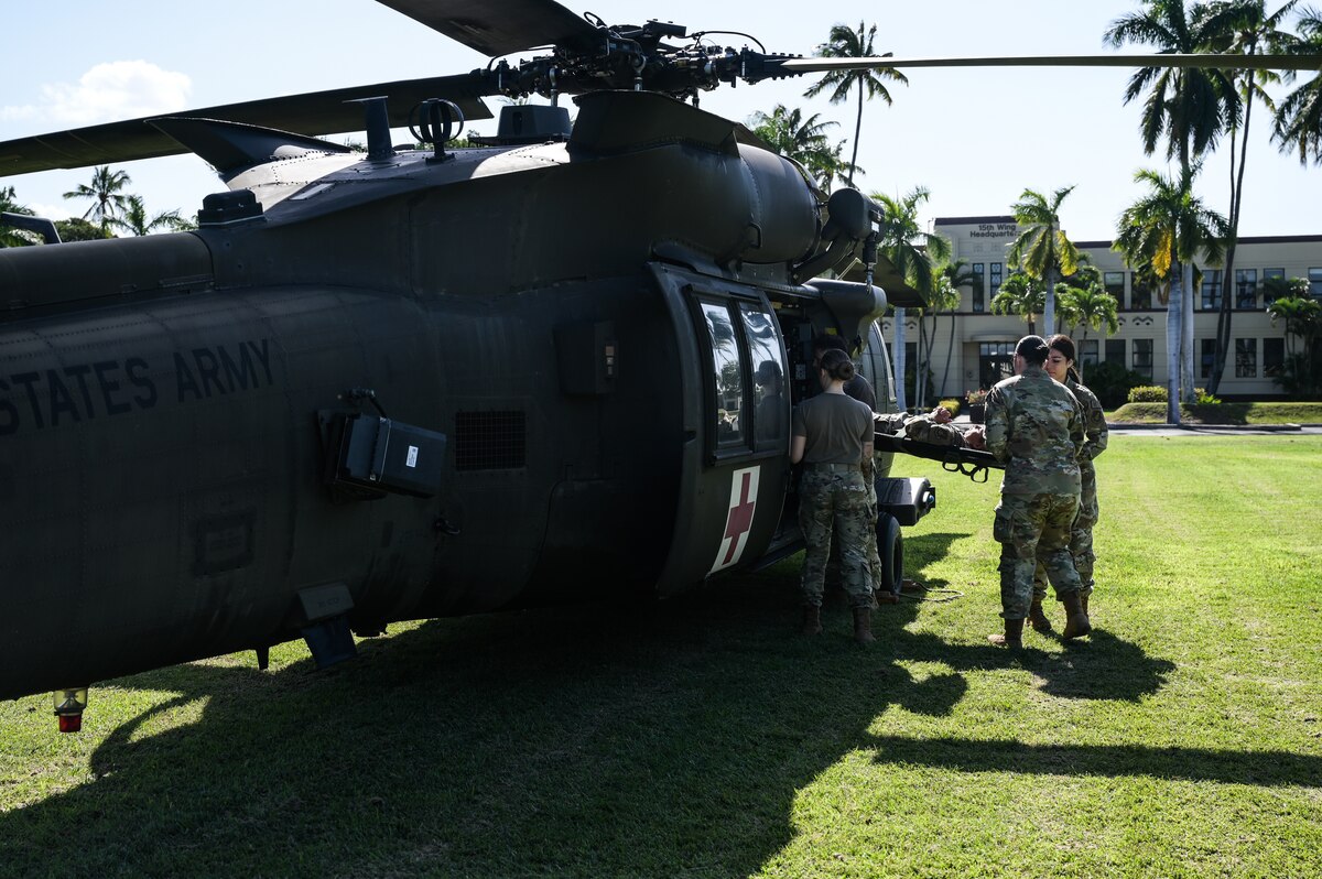 Airmen assigned to the 15th Medical Group and soldiers from the 25th Combat Aviation Brigade practice patient litter carries to and from a HH-60 Black Hawk during a Joint Base Readiness Exercise at Joint Base Pearl Harbor-Hickam, Hawaii, Mar. 8, 2023. The 15th Wing’s ability to surge combat-ready forces across the theater is critical to supporting regional alliances, partnerships and stability. (U.S. Air Force photo by Staff Sgt. Alan Ricker)